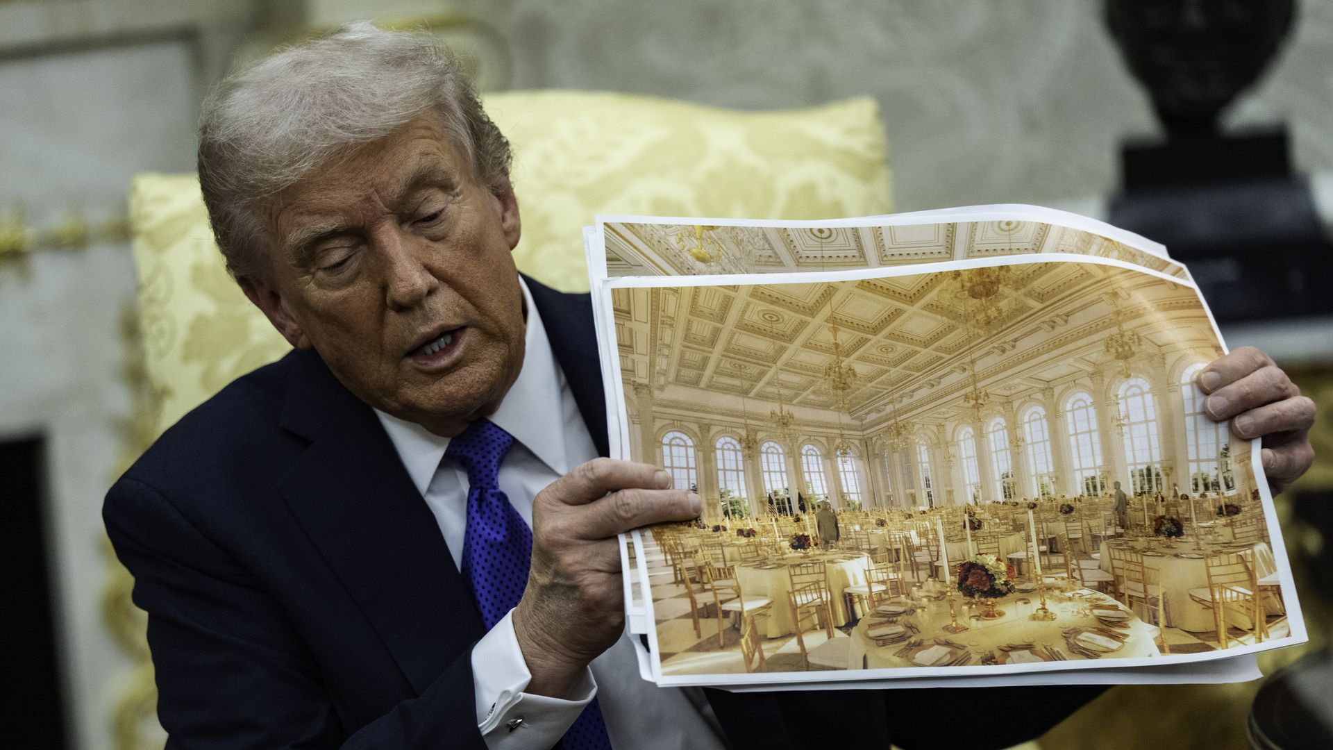 President Donald Trump holds up a photo of a proposed White House ballroom while speaking in the Oval Office during a meeting with NATO Secretary General Mark Rutte.