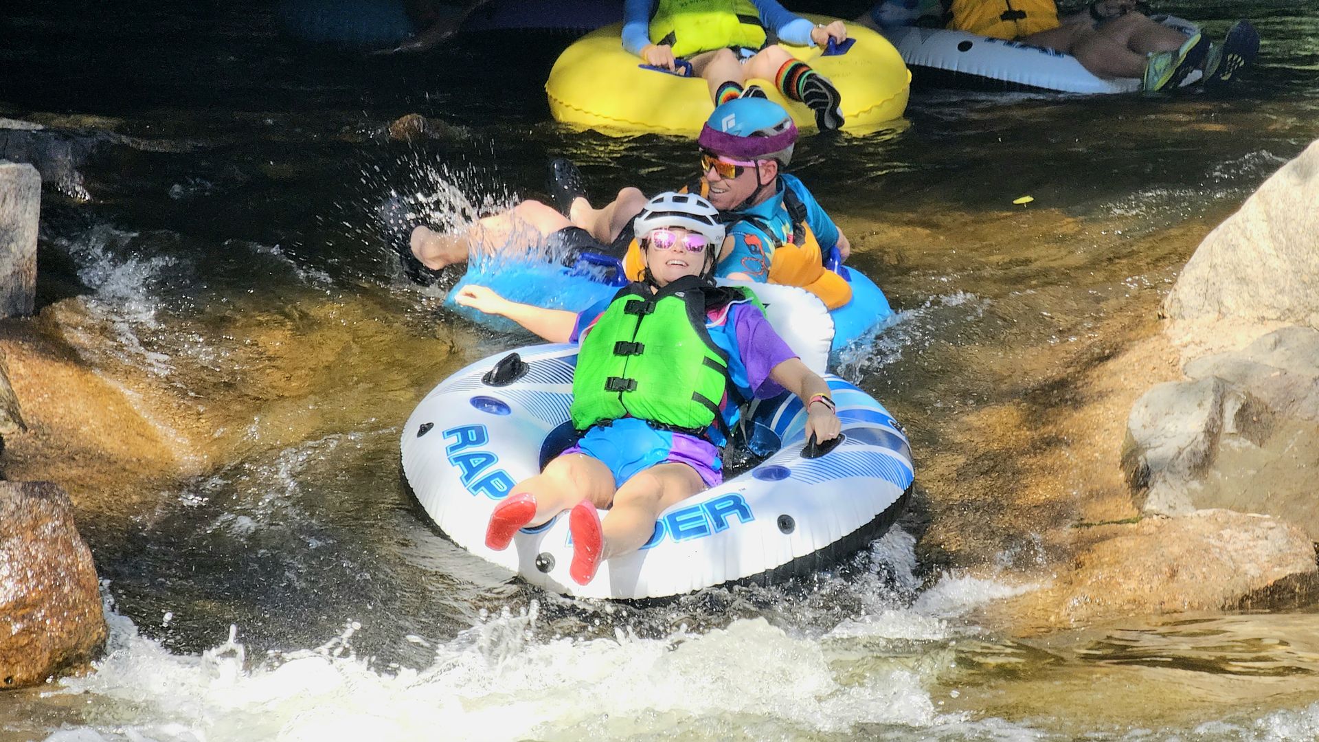 Two tubers come down a rapid on Tube to Work Day in Boulder.
