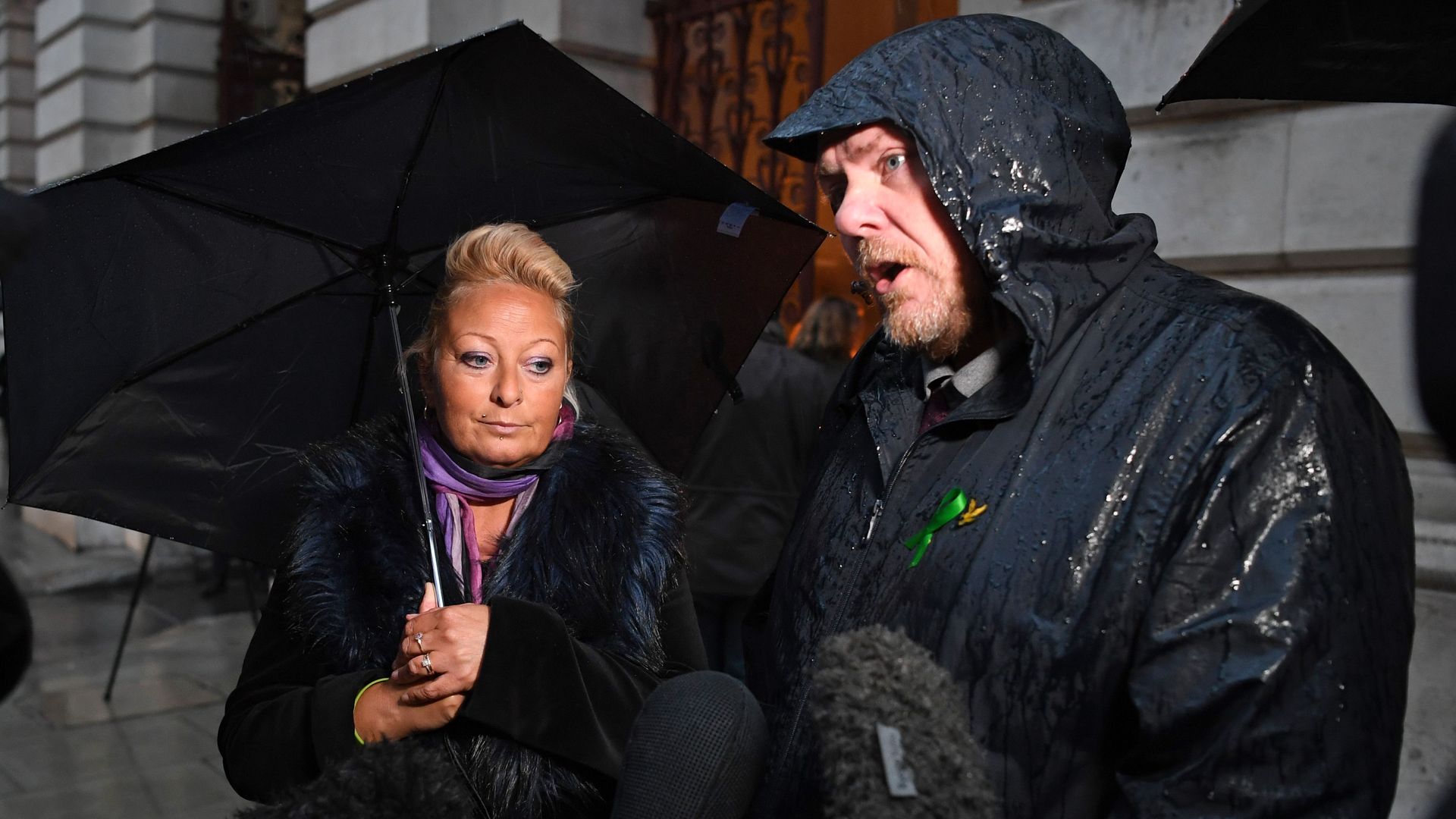 Charlotte Charles (L) the mother of teenage motorcyclist Harry Dunn who was killed in a collision with a car by US citizen Anne Sacoolas, stands beside her husband Bruce Charles