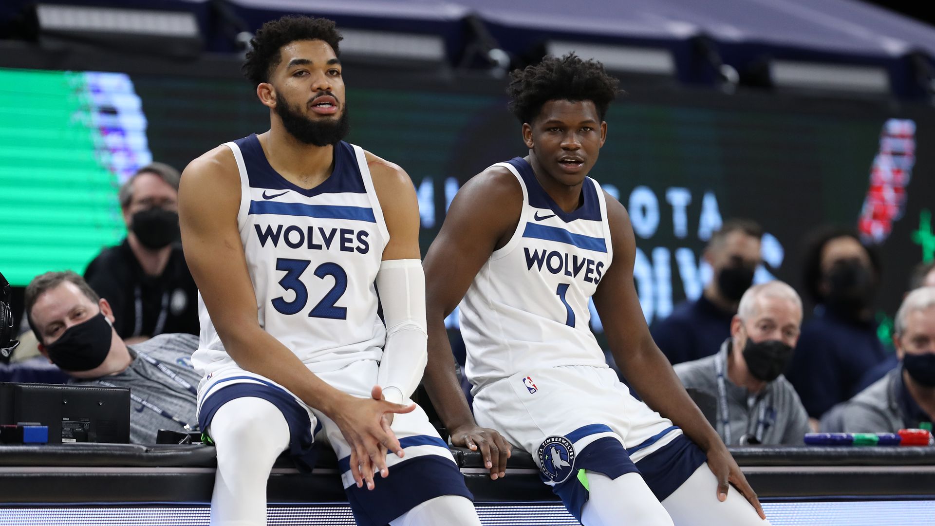 Karl-Anthony Towns and Anthony Edwards sit on the scorers table 