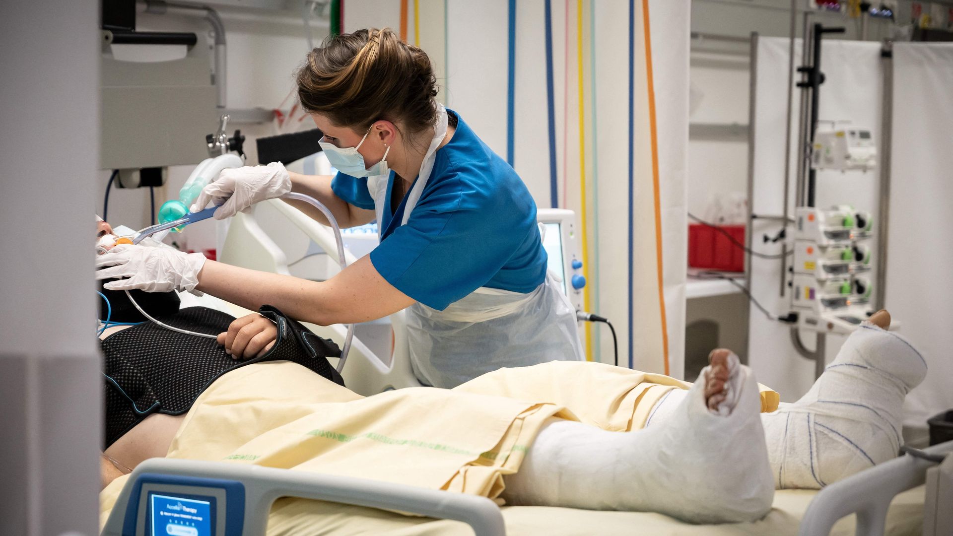 A nurse tends to a patient in France.