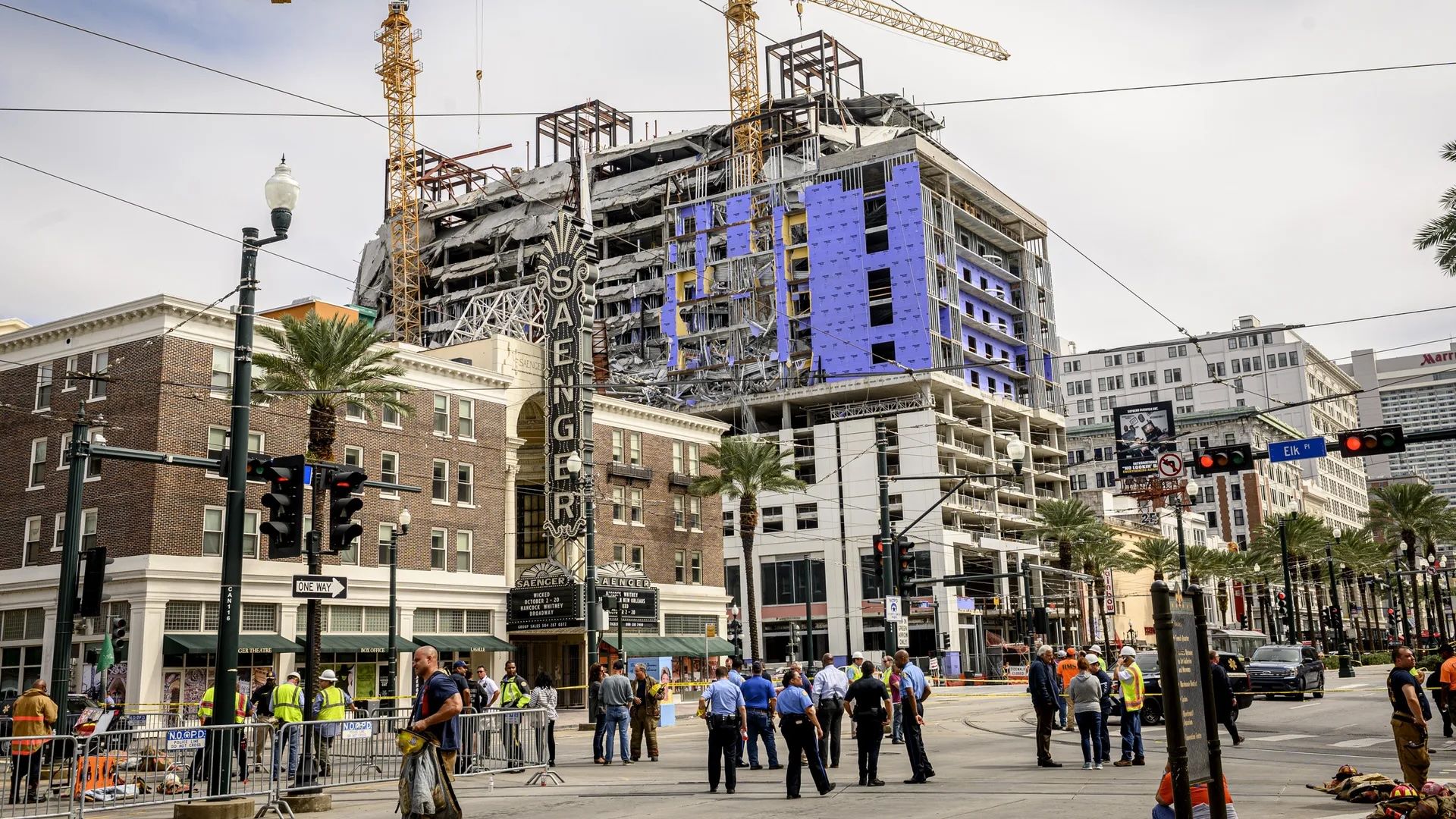 Image shows police in front of the collapsed Hard Rock hotel