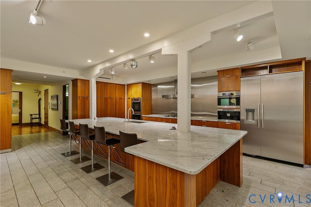A high-end kitchen with wood cabinets and stainless appliances