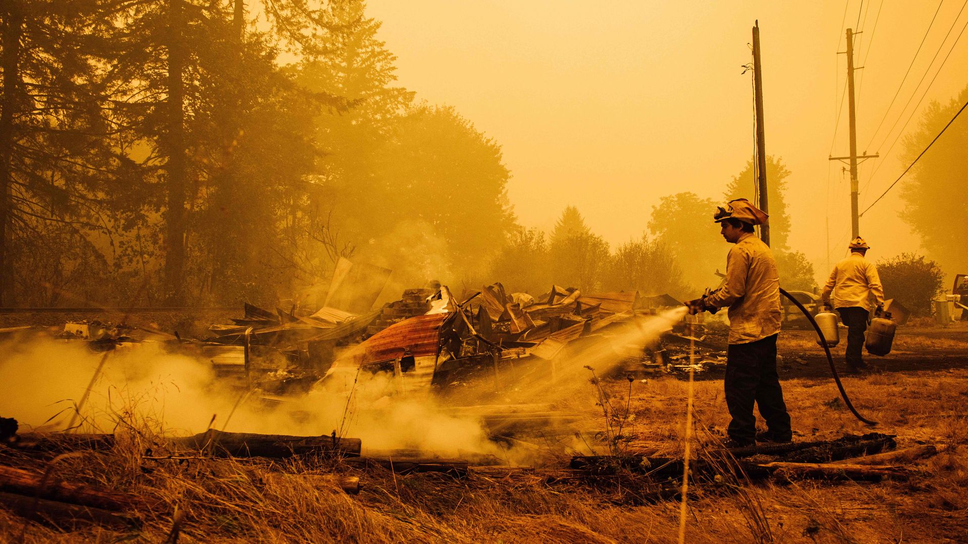 Oregon firefighters put out embers in Mill City, Oregon, on September 10, 2020, as they battle the Santiam Fire.