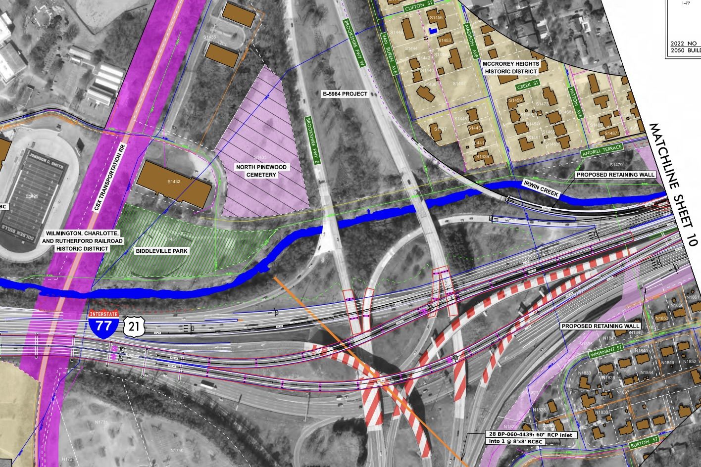 Engineering site plan over a map: I-77 and US-21 interchange, rail lines, Irwin Creek, North Pinewood Cemetery, Biddleville Park, and proposed retaining walls with colored zones.