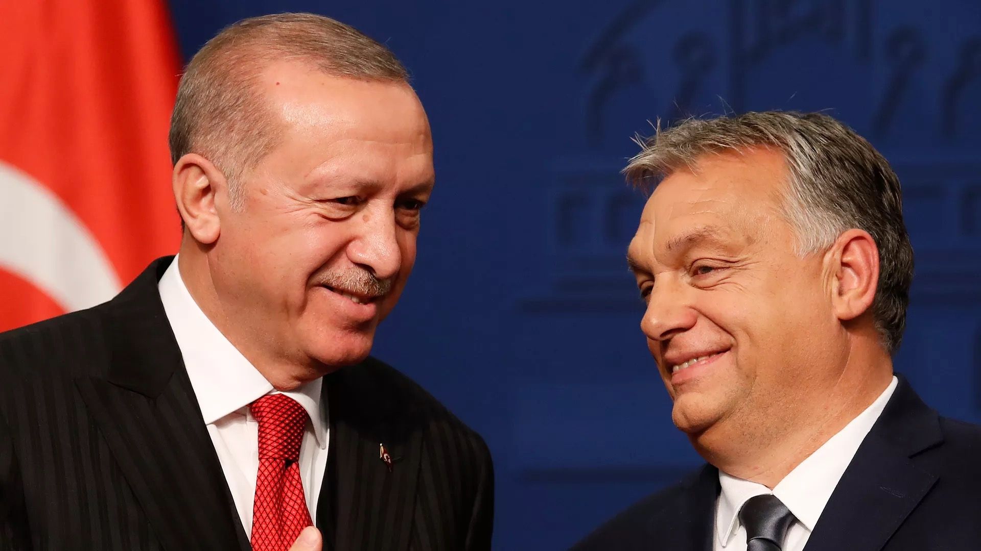 The president of Turkey and prime minister of Hungary are seen smiling together.