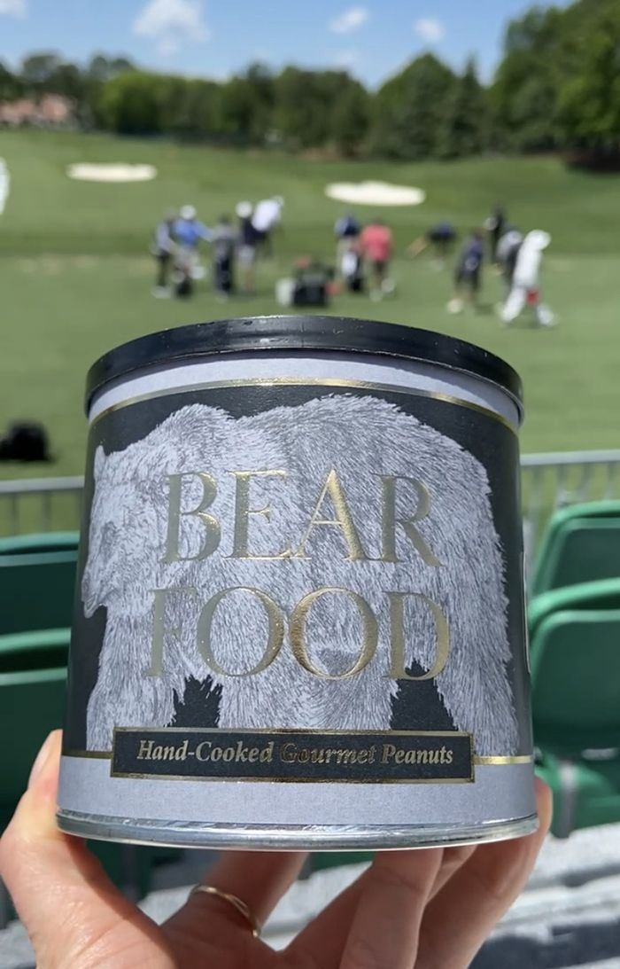 Can of gourmet nuts on a golf course.