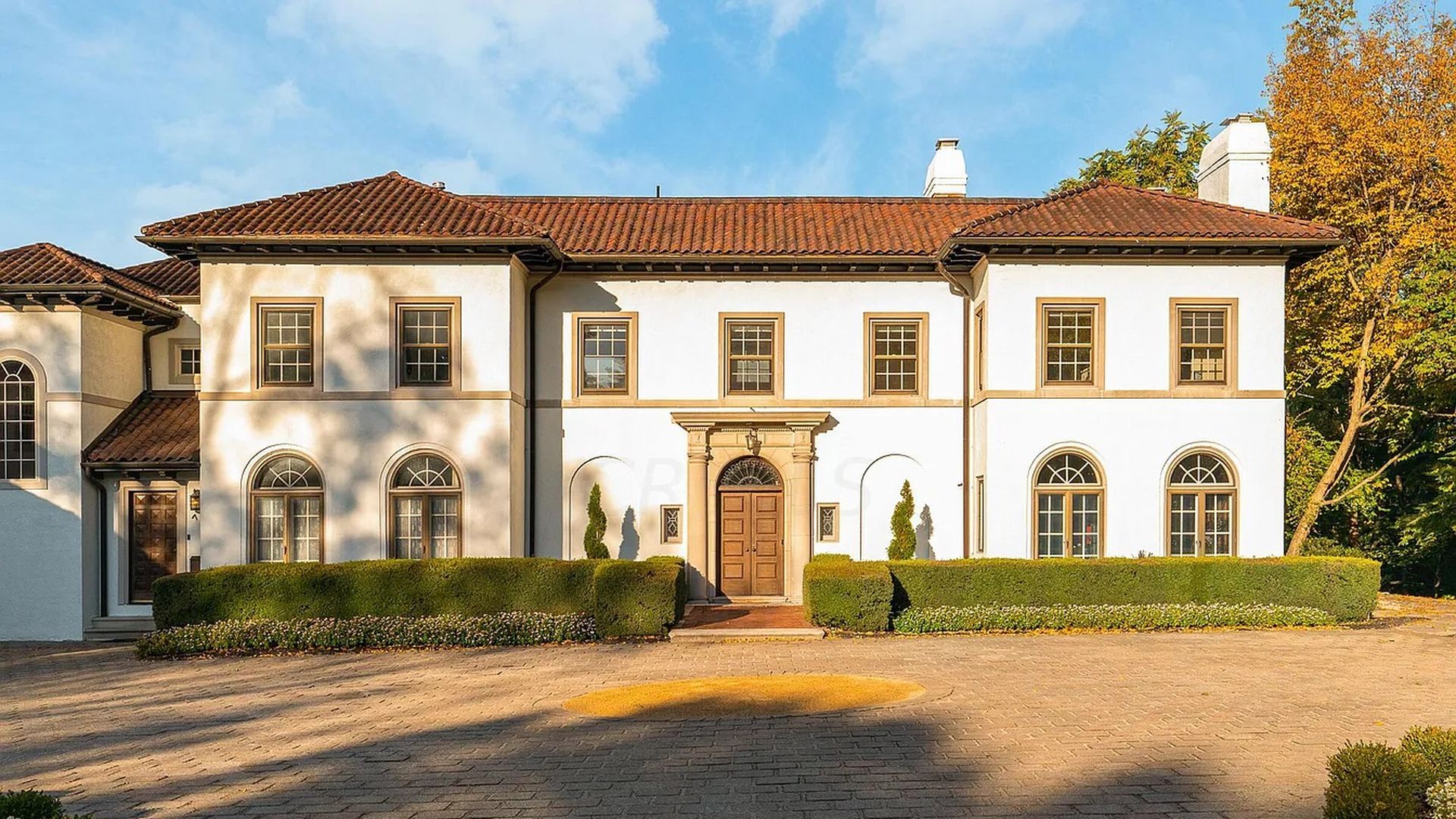 The facade of a Spanish Revival mansion.