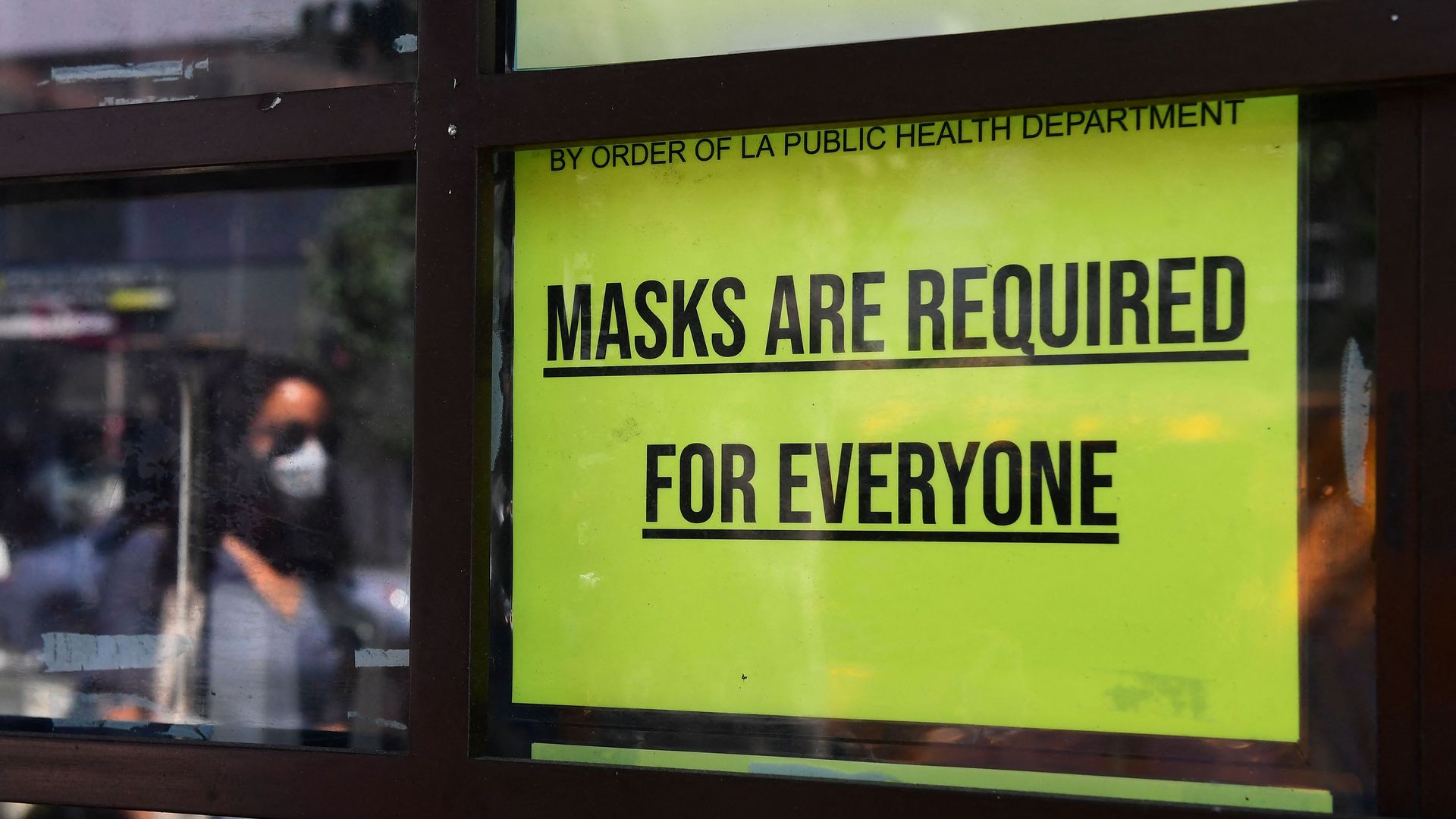 A storefront sign reminds people masks are for everyone on July 19, 2021 in Los Angeles, California.