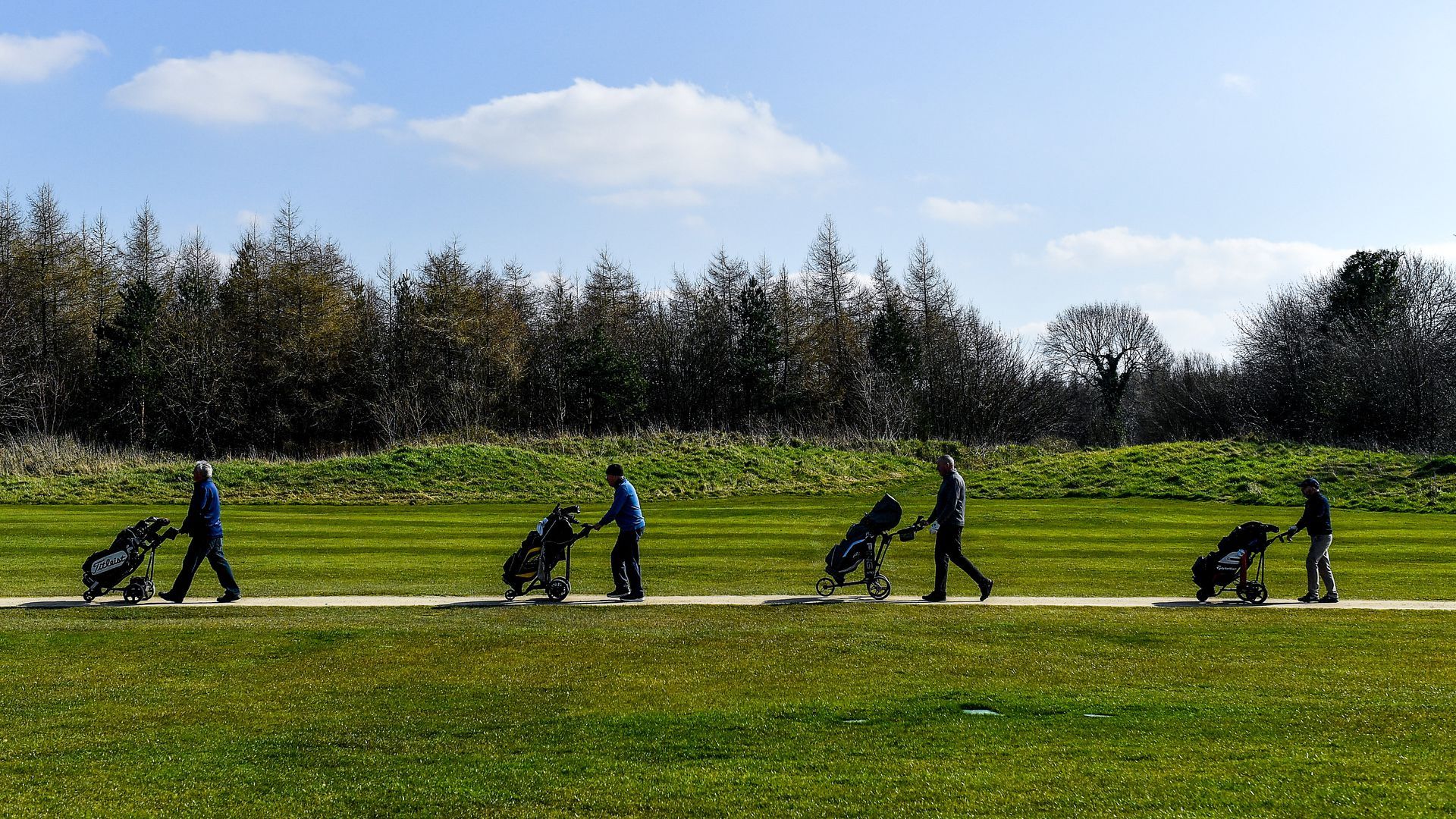 Members of Craddockstown Golf Club in Kildare, Ireland, enjoy a round of golf while practicing social distancing.
