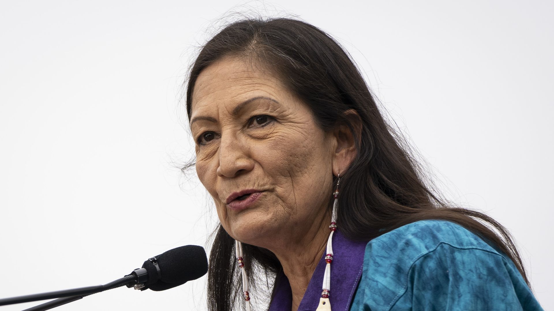 Photo of Deb Haaland speaking into a mic