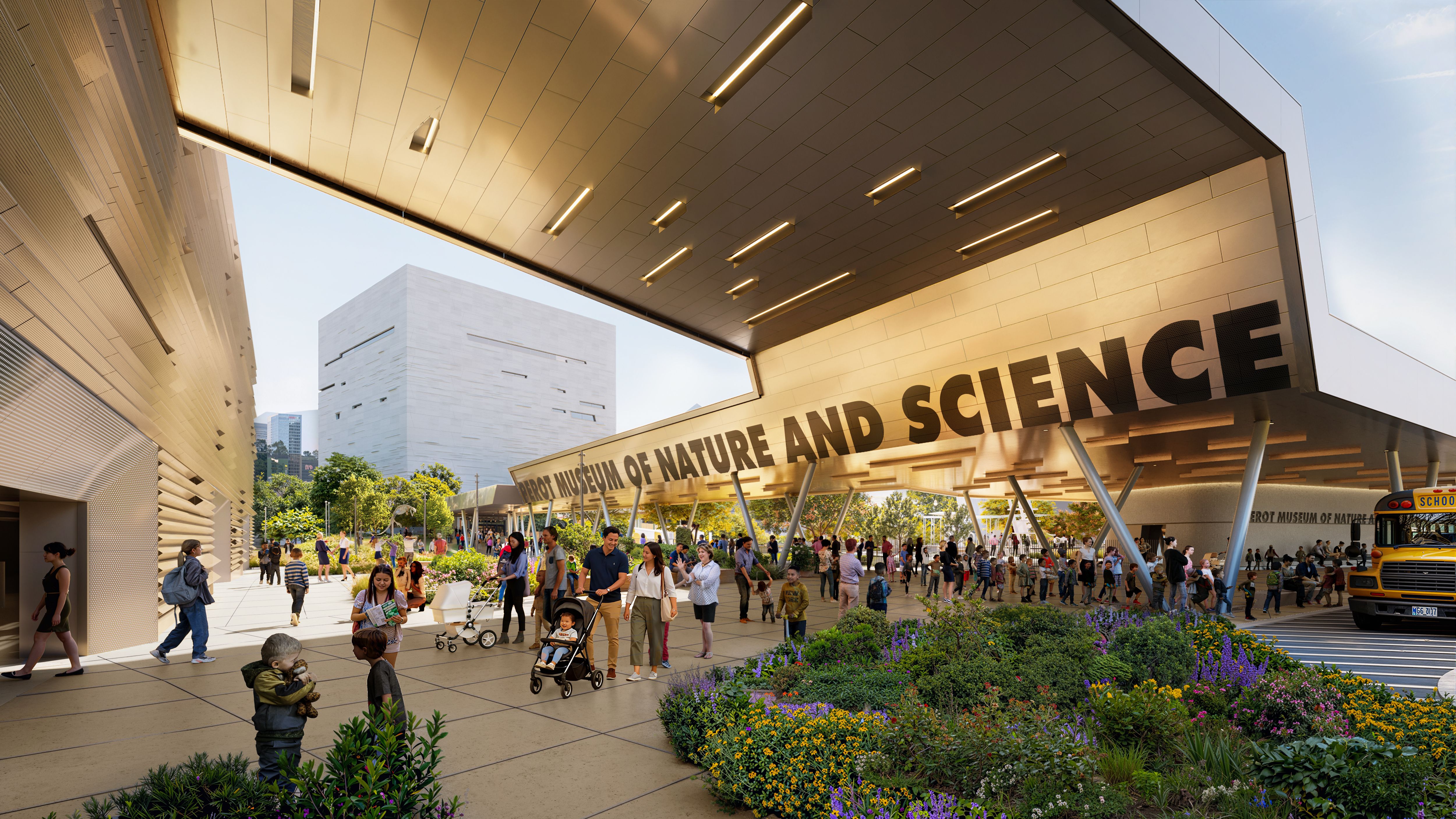 Exterior view of the Perot Museum of Nature and Science with a large overhead canopy, modern beige walls, and a crowd of families, strollers, and a yellow school bus; purple flowers line the landscaped foreground.
