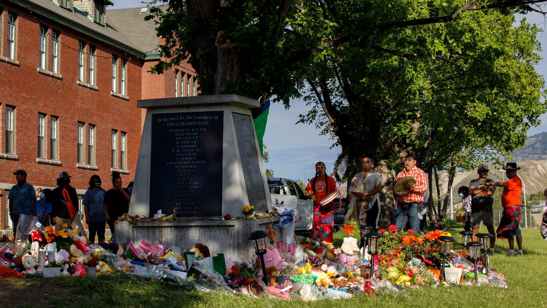 A group gathers to honor the 215 children whose remains have been discovered buried near the facility, in Kamloops, British Columbia, Canada.