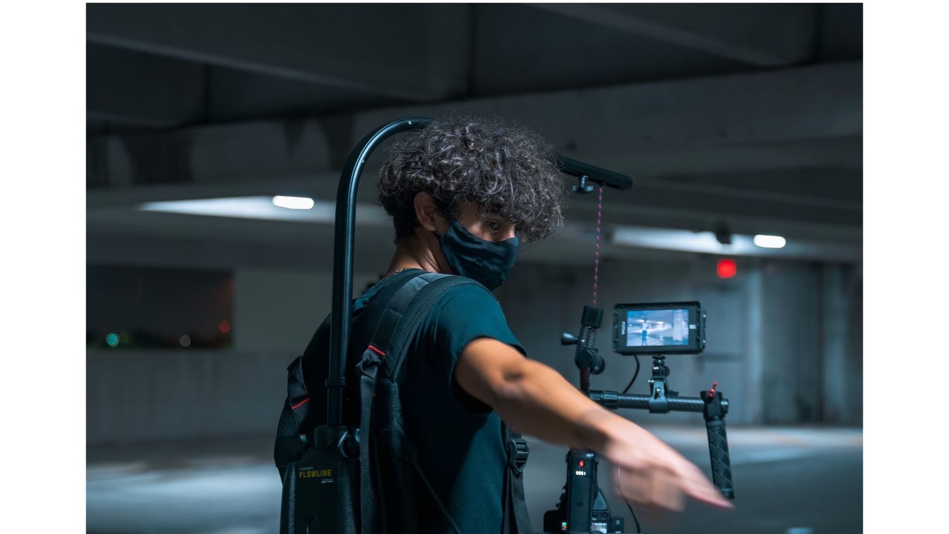 Samuel Correa, a high school student, holds a phone camera attached to his body in a dark space that looks like a garage.