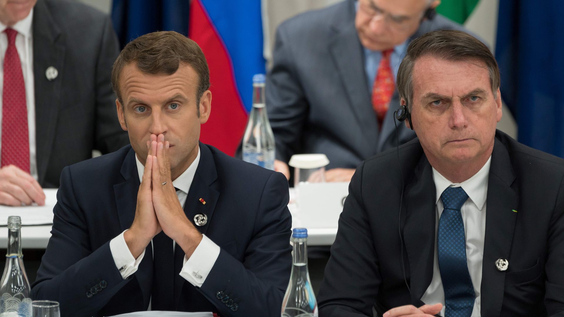 France's President Emmanuel Macron (L) and Brazil's President Jair Bolsonaro attend a meeting on the digital economy at the G20 Summit in Osaka on June 28, 2019. 
