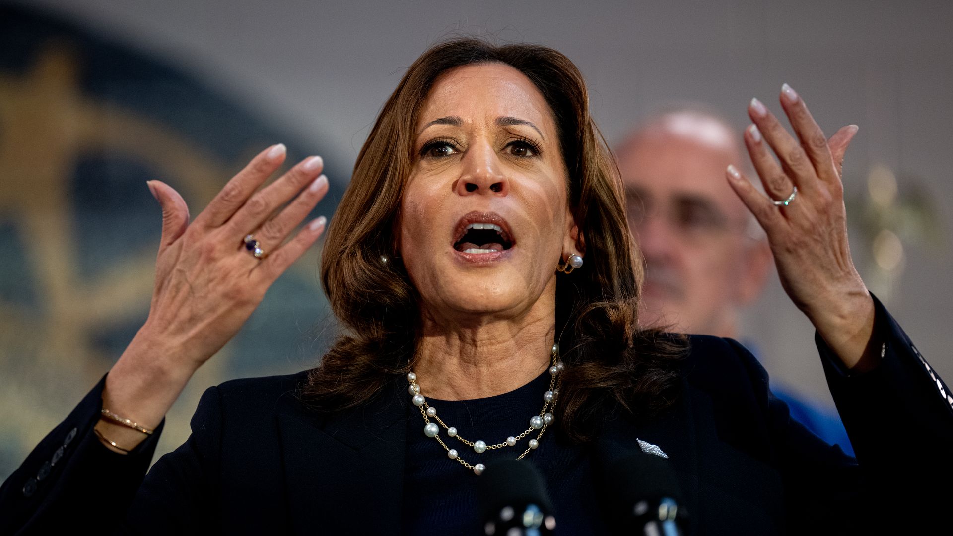 Harris speaks with hands in front of her 