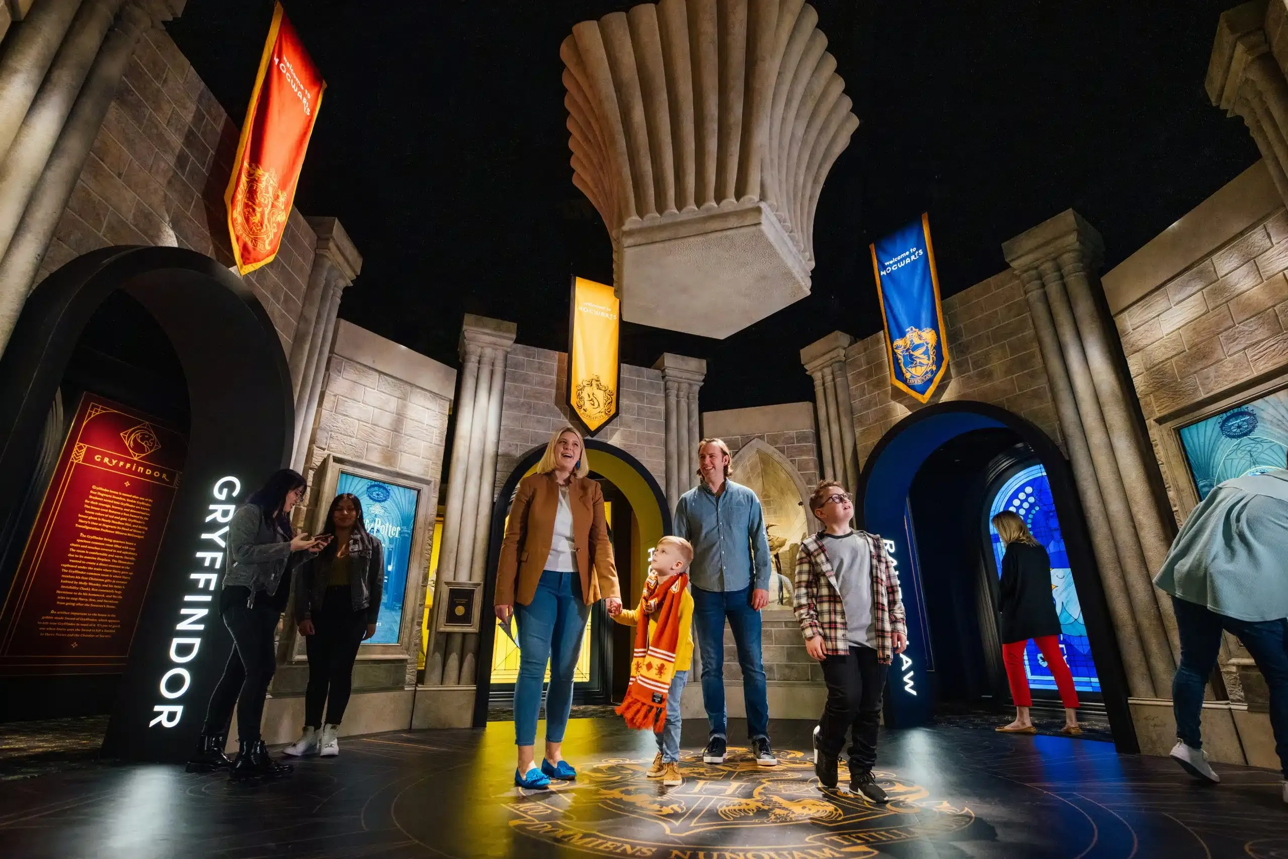 People walk through Harry Potter: The Exhibition. 