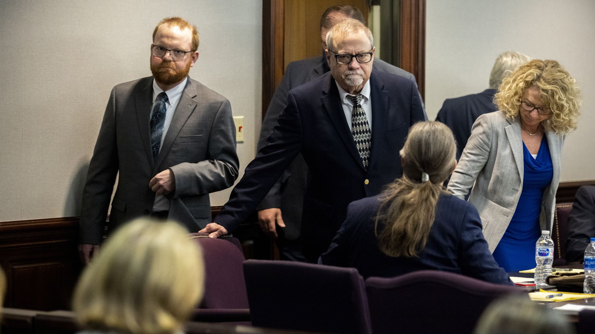 Travis and Gregory McMichael arrive in court in suits