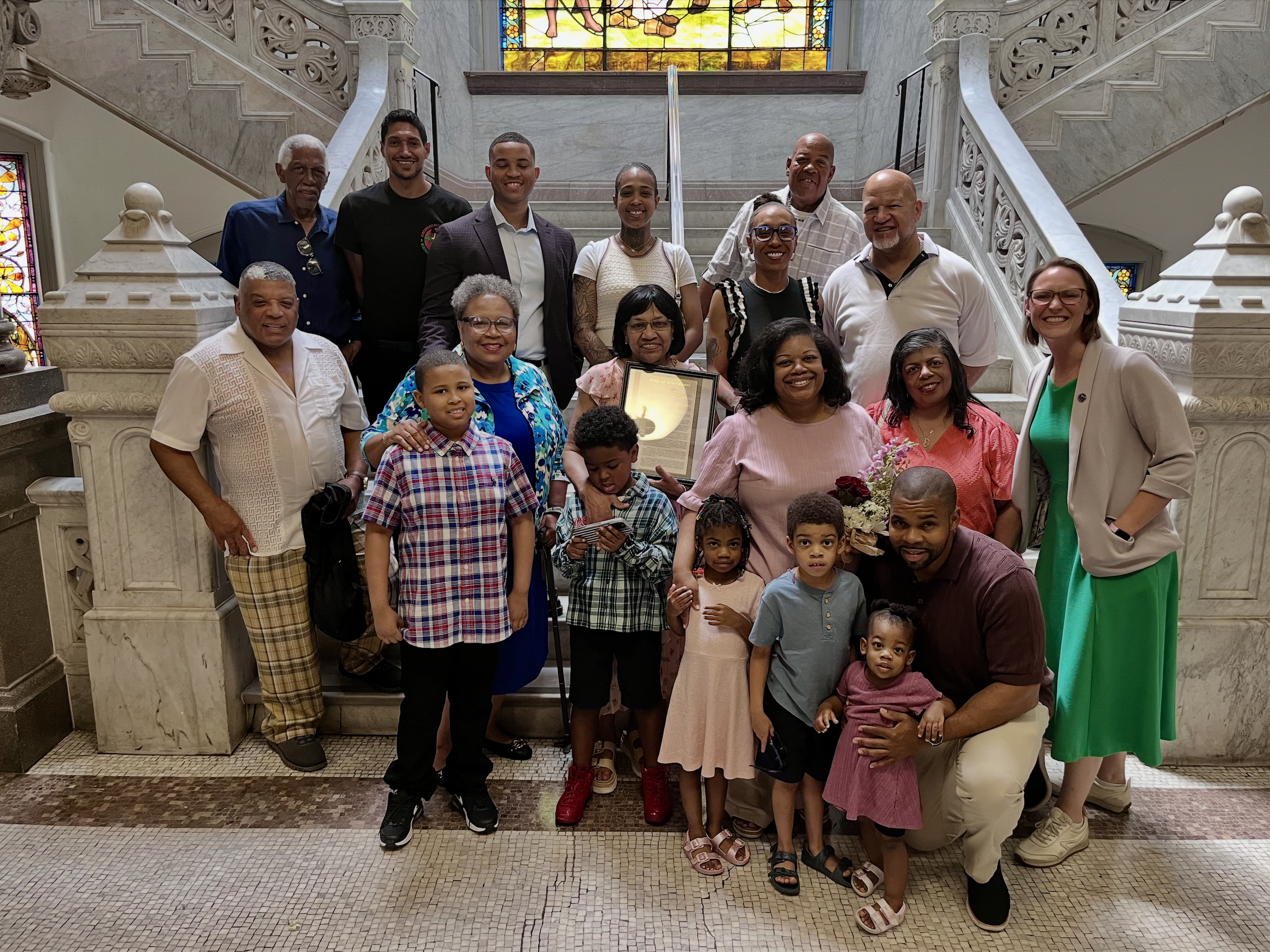 Kinney, Jr.'s family of about 20 people stands at a set of ornate stairs while attending a recent City Council recognition.