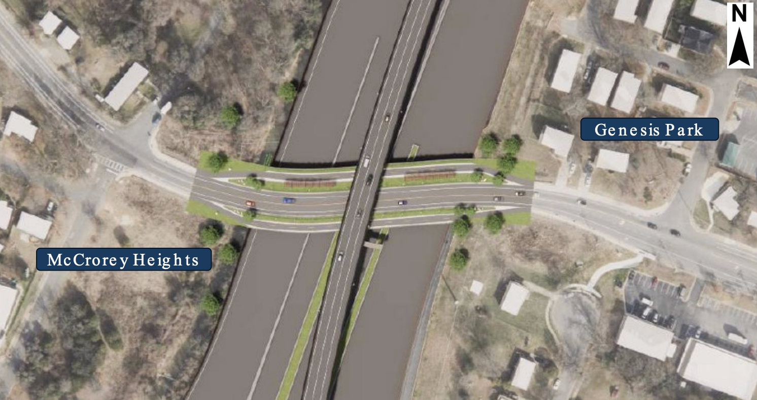 Aerial view of a multi-level highway interchange with an elevated overpass crossing a parallel road; green medians line the ramps. Surrounding residential area; blue labels read Genesis Park and McCreery Heights; north arrow in the corner.