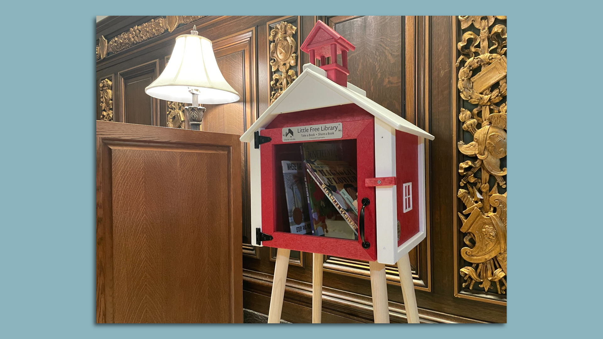 A red little free library box with titles banned by other states
