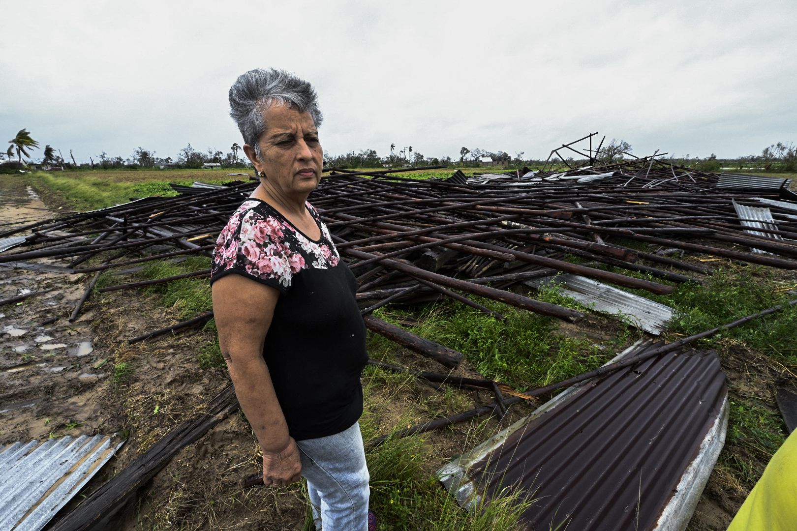 woman outside her destroyed house cuba 