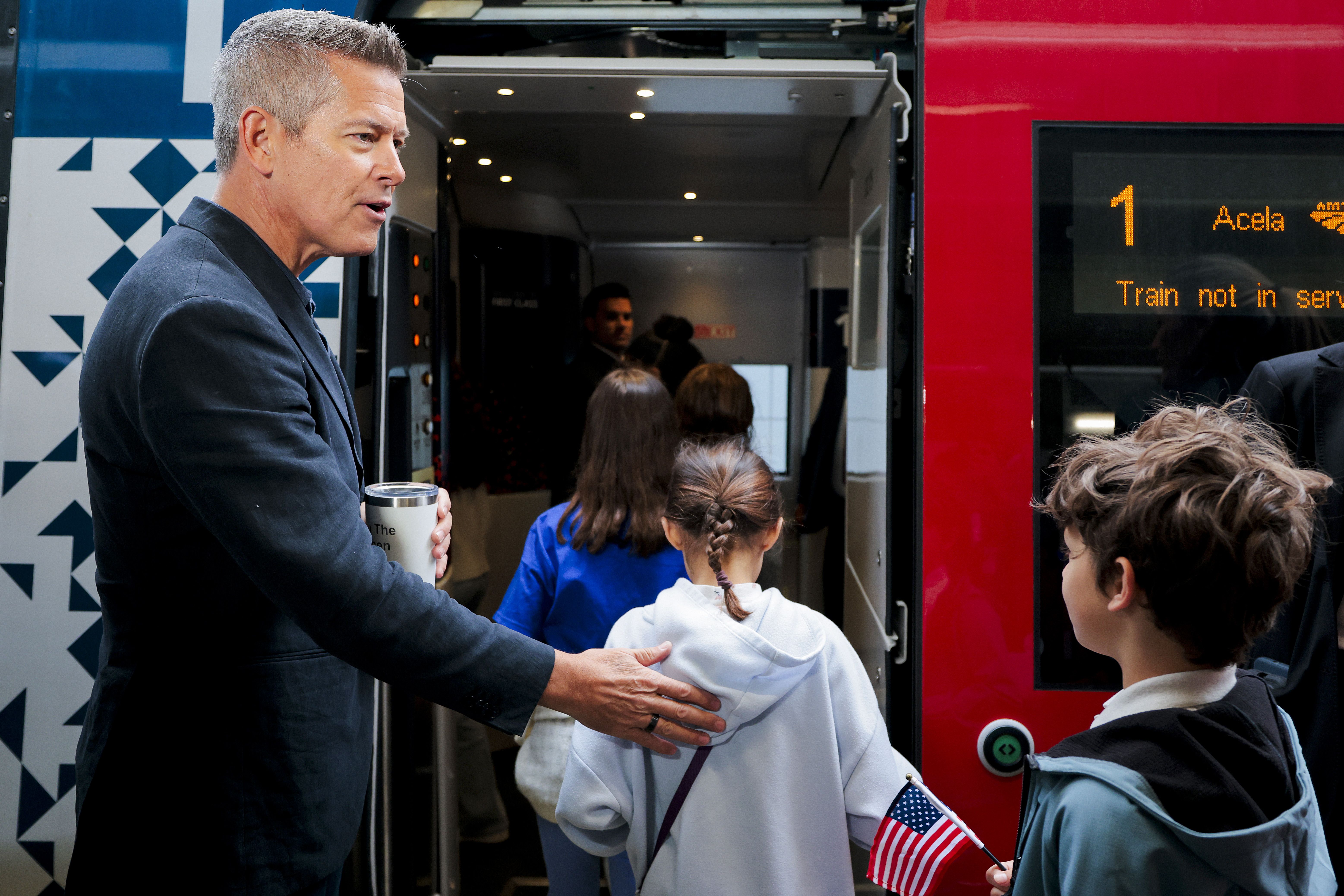 WASHINGTON, DC - MAY 07: U.S. Transportation Secretary Sean P. Duffy assists a group of 4th graders to board Amtrak's Freedom 250 Acela Train at Union Station on May 07, 2026 in Washington, DC. The new Amtrak train departed from Union Station and headed to William H. Gray III 30th Street Station in 