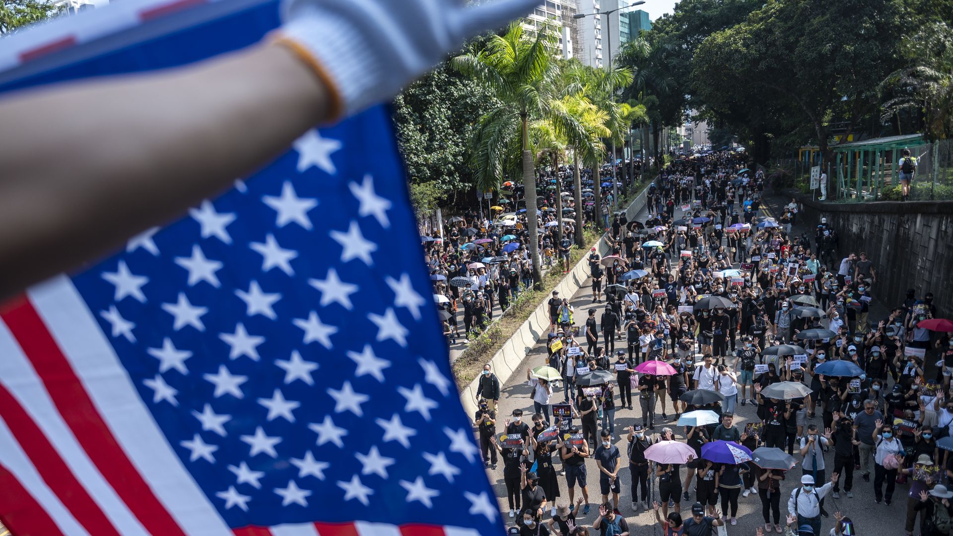 A Protester is seen holding up a US Flag above other protester during an Anti-Government Protest in Tsim Sha Tsui district in Hong Kong, China, October 20