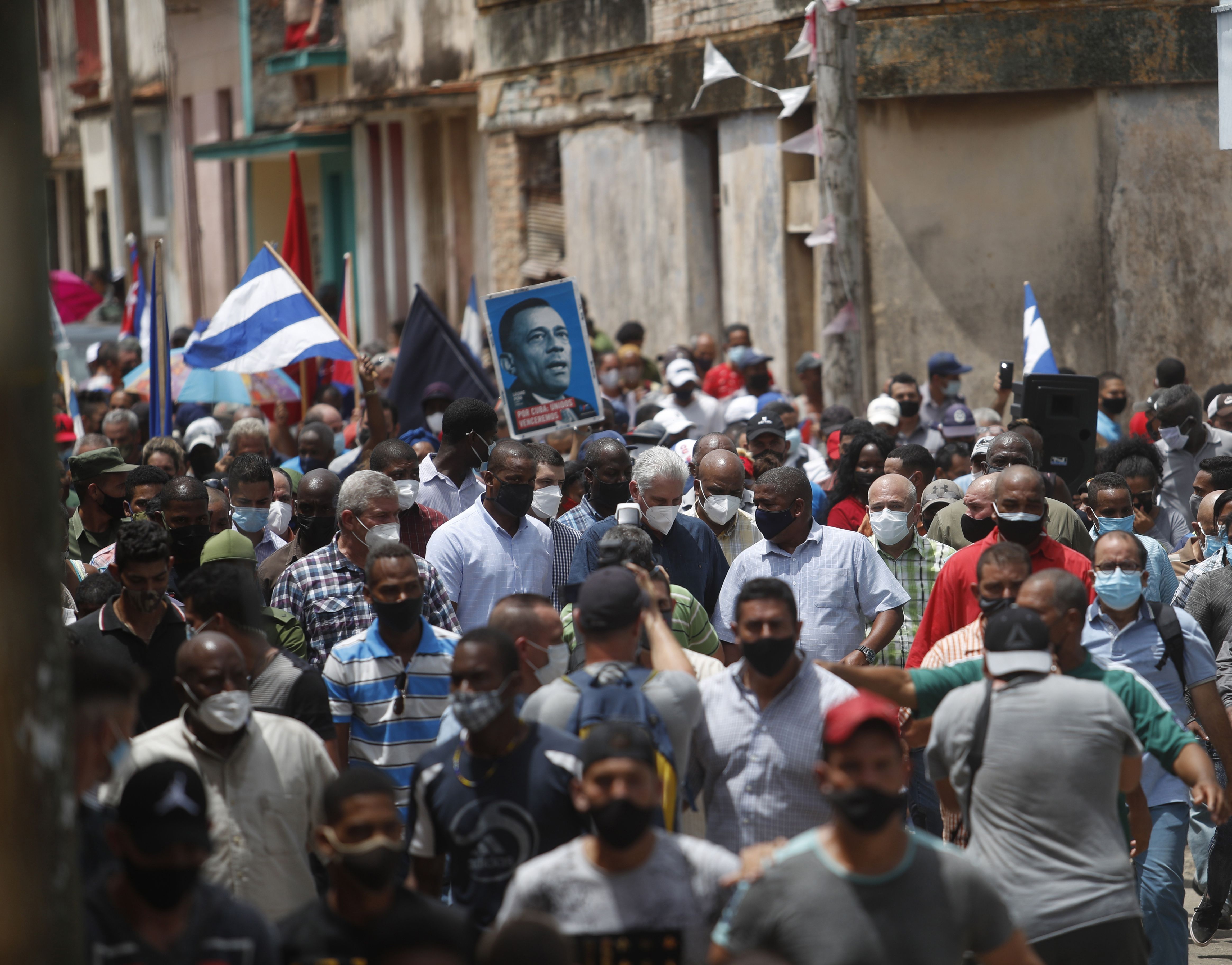  Cuban President Miguel Diaz-Canel (C) walks alongside his supporters in the town of San Antonio de los Banos, Cuba, Sunday, July 11