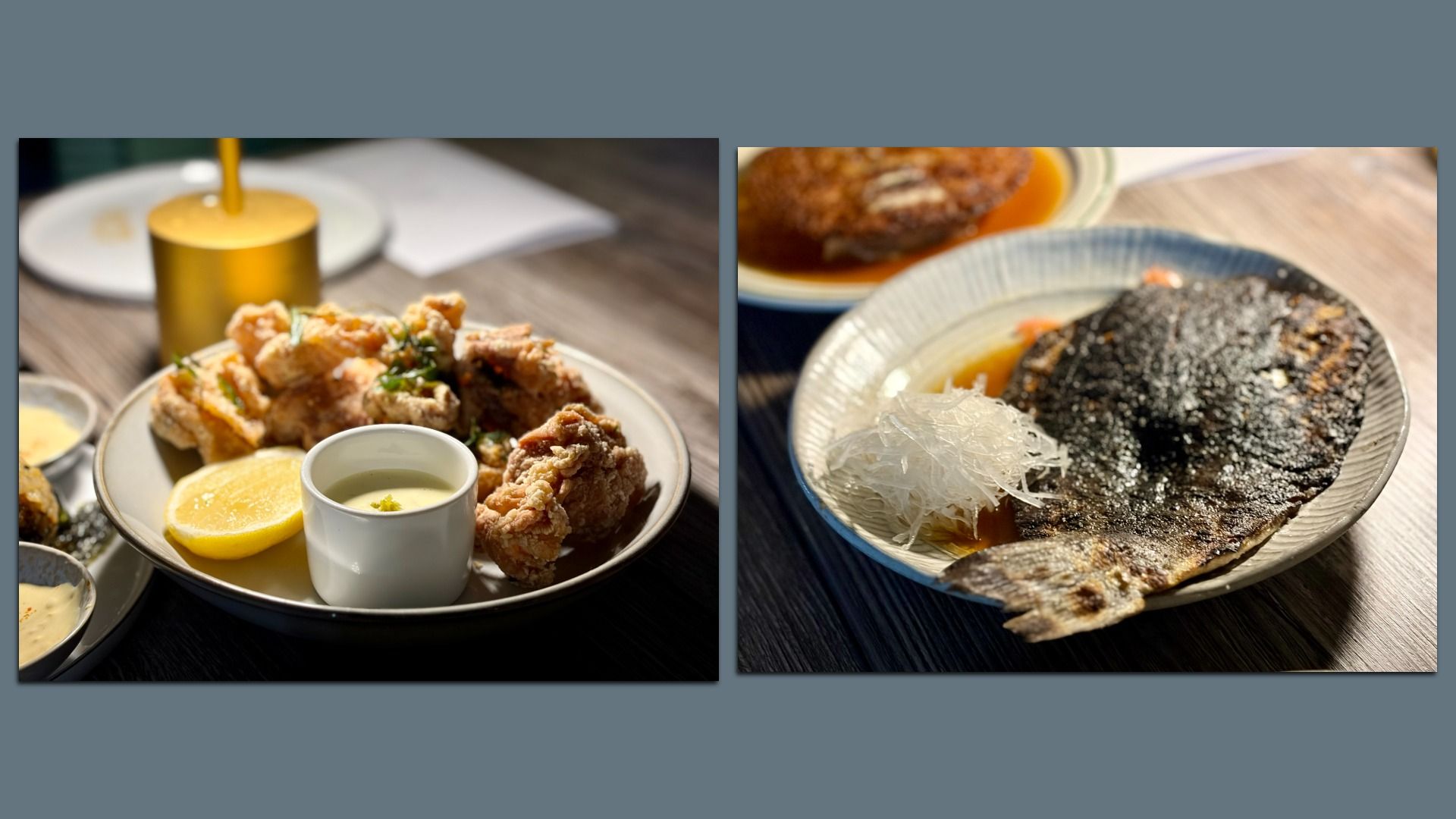 Two plates of food on a wooden table: left plate has fried chicken pieces with a lemon half and a small cup of sauce; right plate has a grilled fish with shredded garnish in a light sauce.