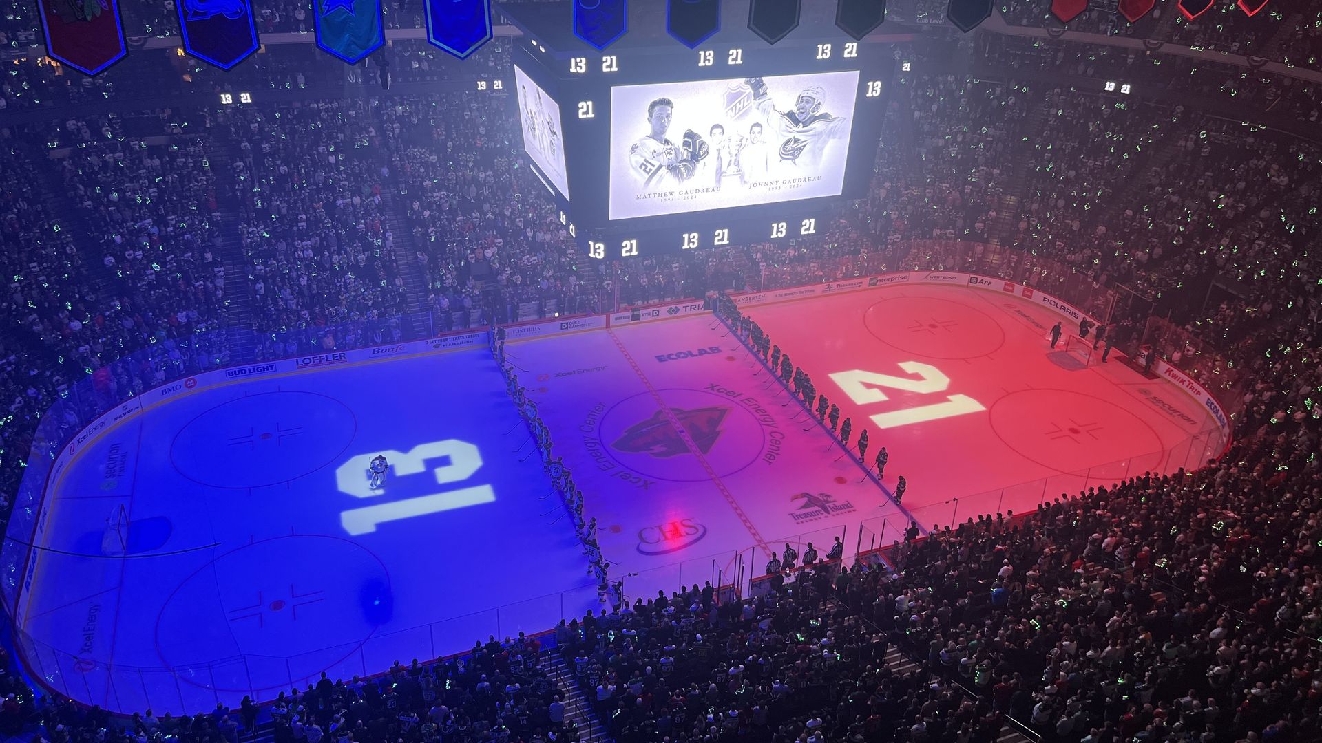 An overhead shot of the Minnesota Wild hockey ring, lit up to honor former Blue Jackets player Johnny Gaudreau. 