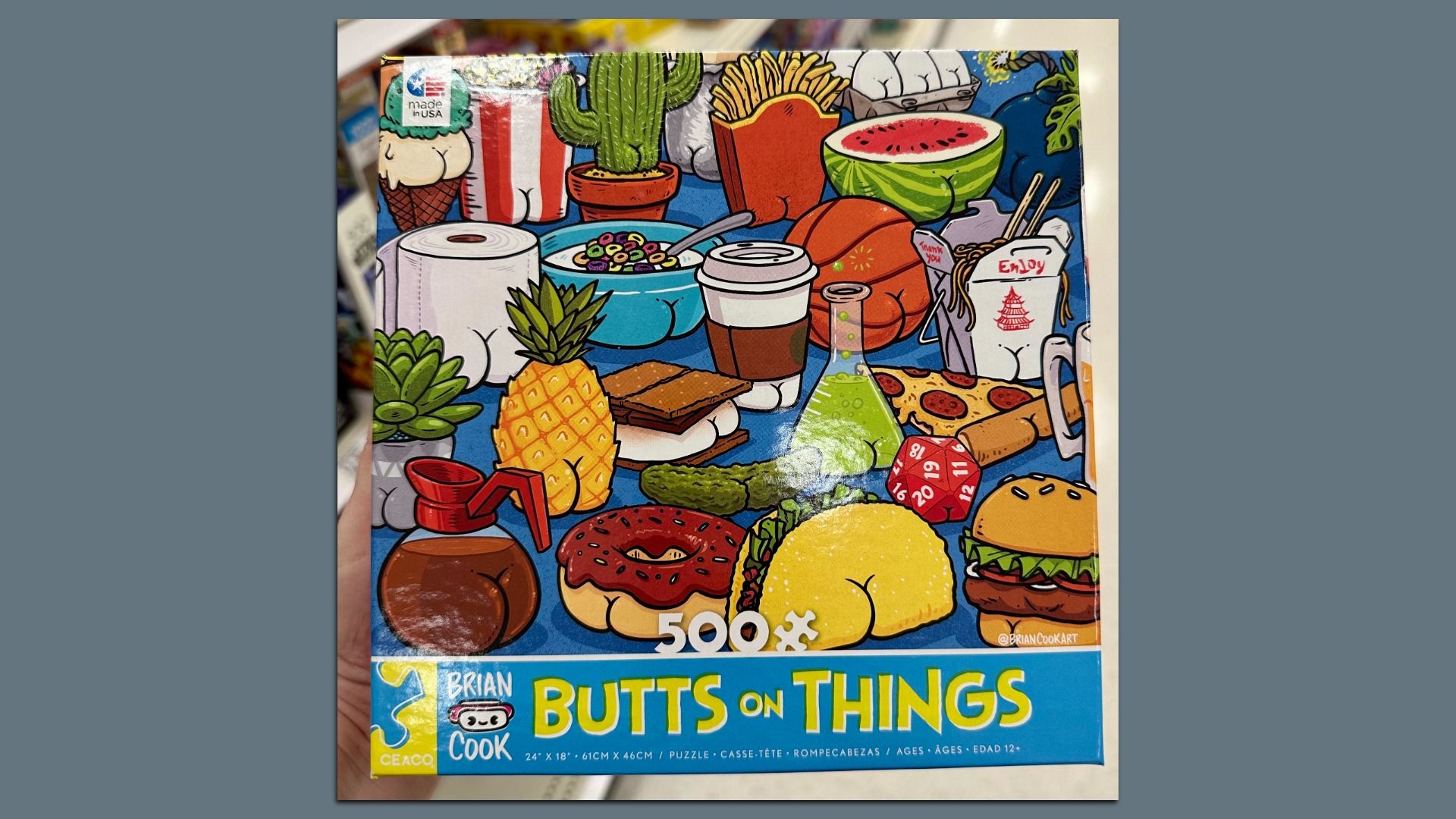 Colorful cartoon collage of foods on a blue surface: pineapple, watermelon slice, donut, burger, pizza, fries, coffee cup, cereal bowl, cactus, paper towel, bottle, and a game box reading "Butts on Things" in the foreground.