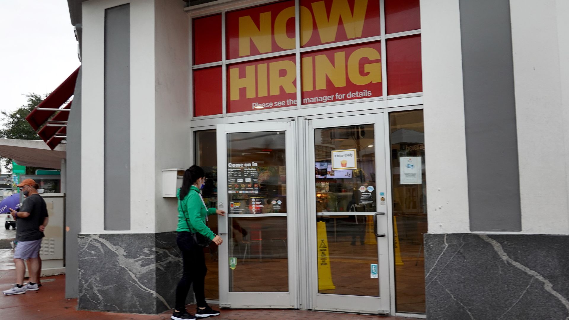 A ''Now Hiring" sign hangs above the entrance to a McDonald's restaurant on Novembe