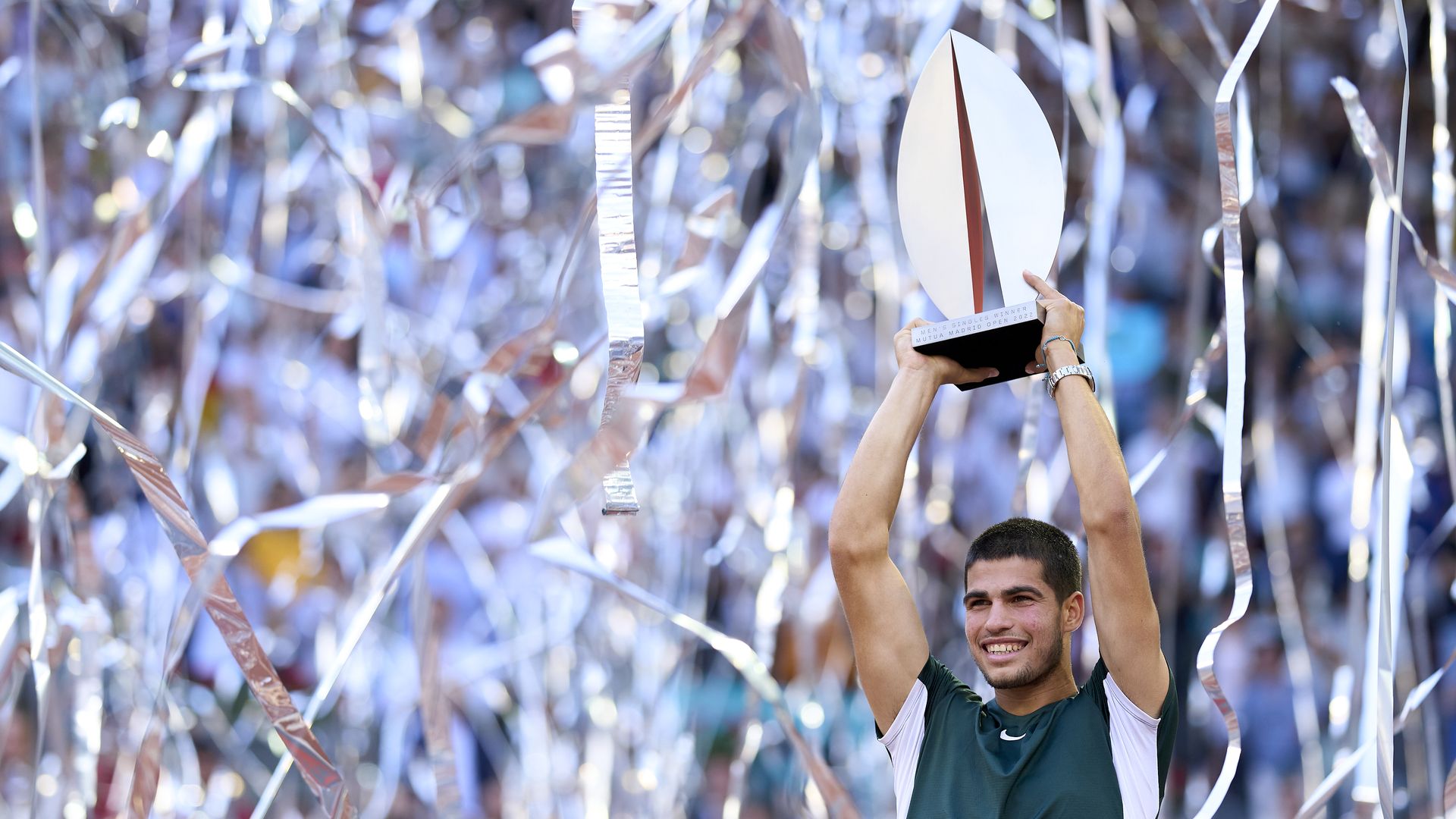 carlos alcaraz hoists trophy in madrid