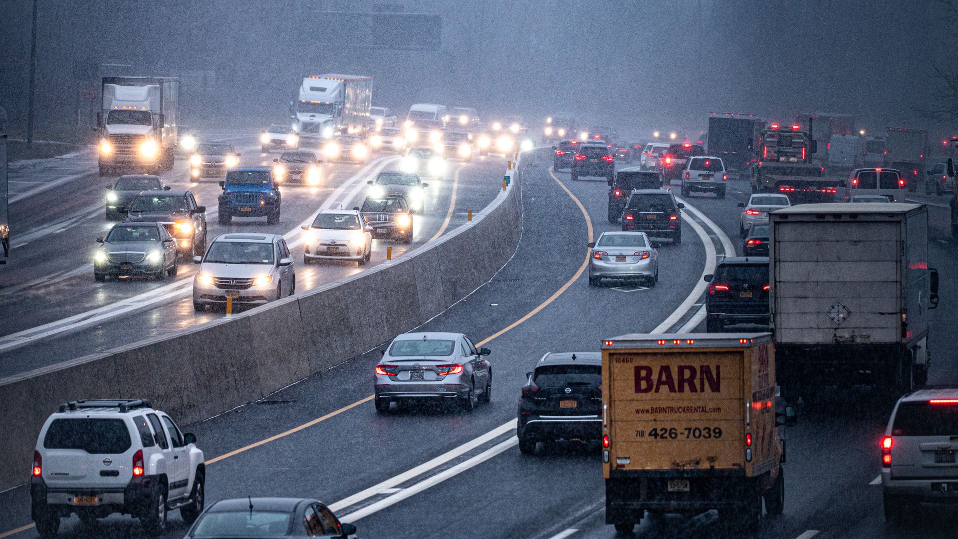 Photo of a highway with cars stuck in traffic amid a snowstorm