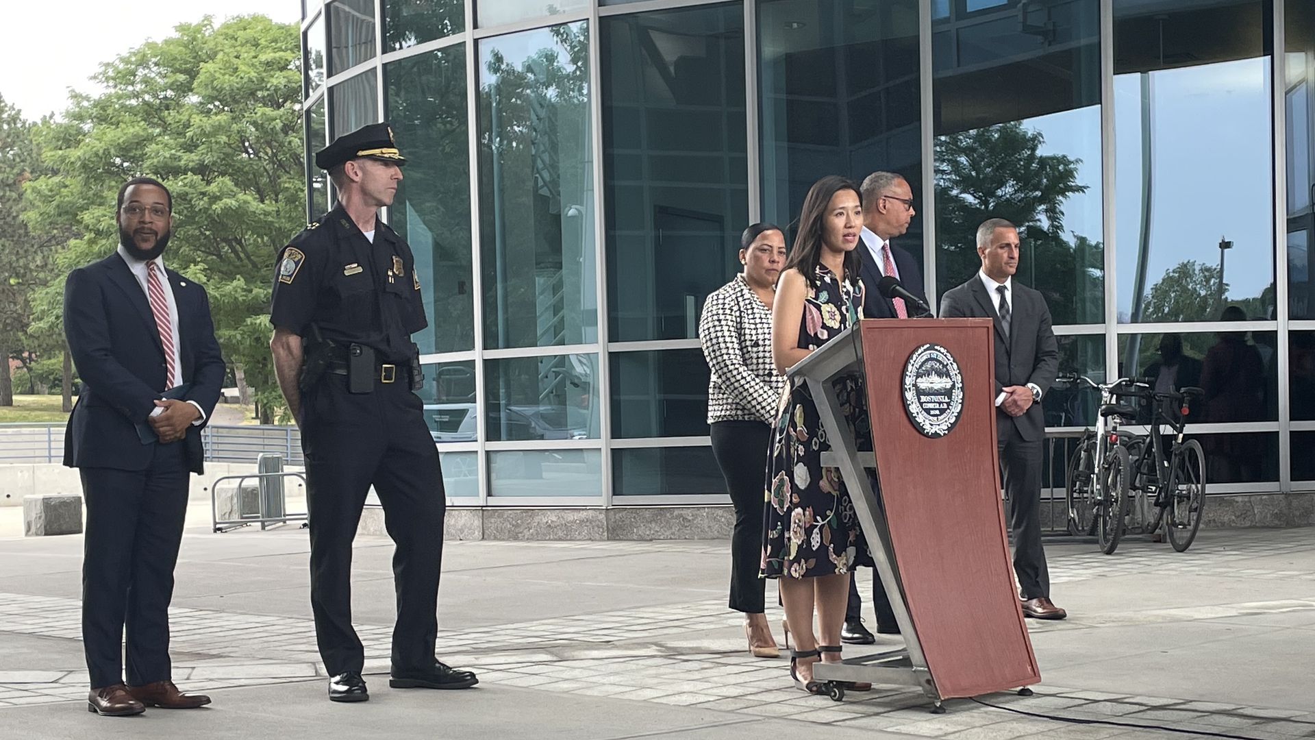 Mayor Michelle Wu speaks at a podium outside the entrance of Boston Police Department headquarters in Boston.