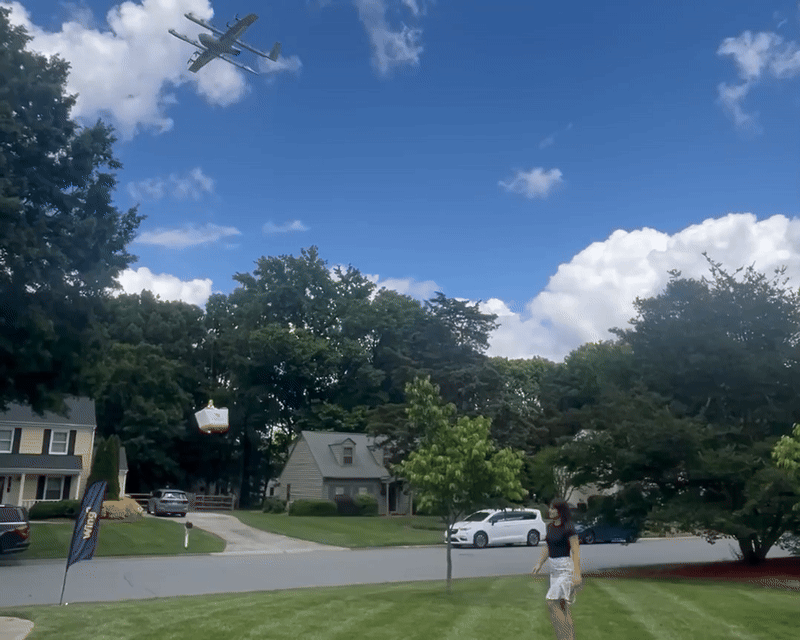 Drone drops a DoorDash box in front of a house