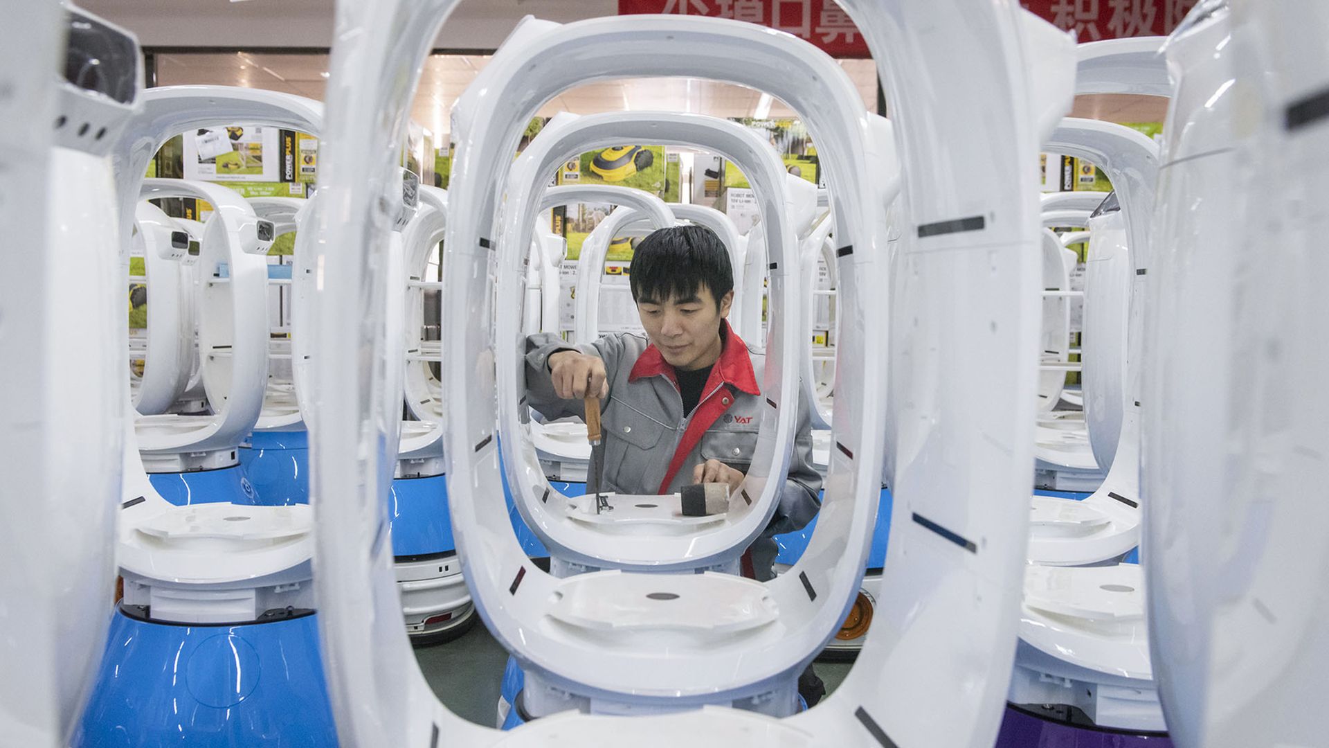 Technician from Zhejiang YAT Electrical Appliance Co.,Ltd checks the service robots which will be used for food and medicine delivery, on January 17, 2021 in Jiaxing, Zhejiang Province of China.