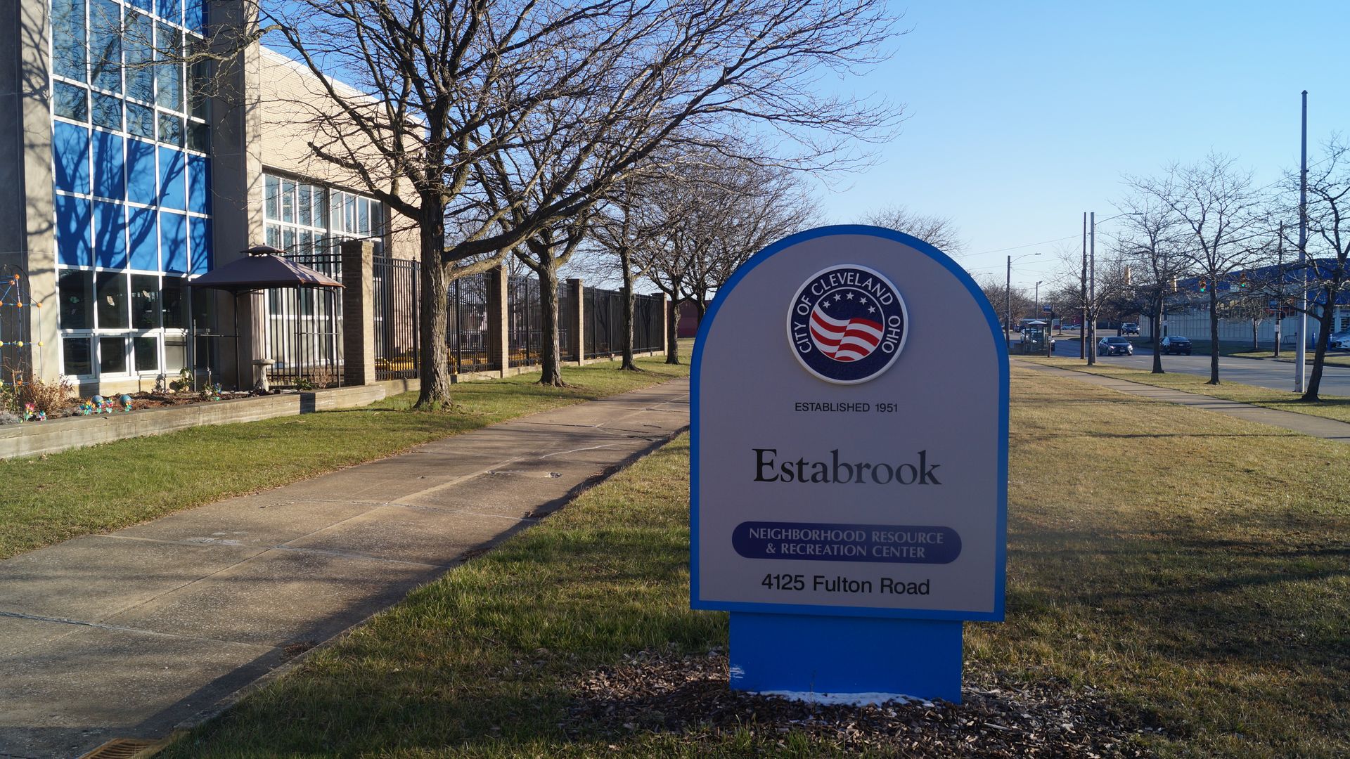 Sign reading "Estabrook" outside Cleveland recreation center on sunny winter day. 