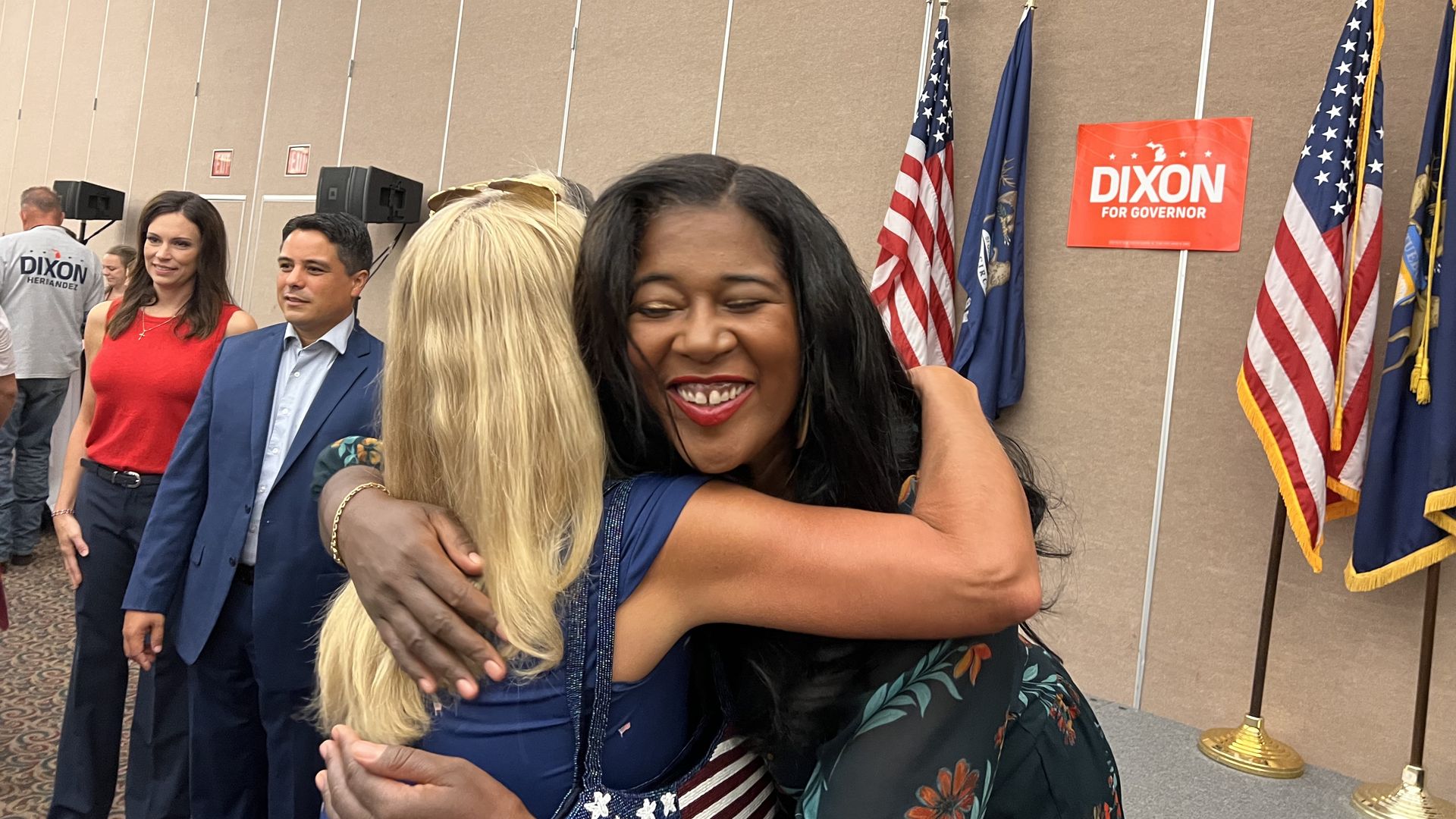 Republican SOS candidate Kristina Karamo hugs a supporter with gubernatorial and lt. gov. candidates Tudor Dixon and Shane Hernandez standing in the background.