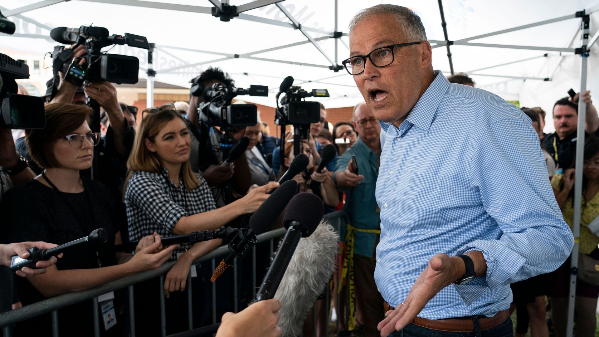  Democratic presidential candidate and Washington Governor Jay Inslee speaks with reporters at the Iowa State Fair August 10, 2019 in Des Moines, Iowa.