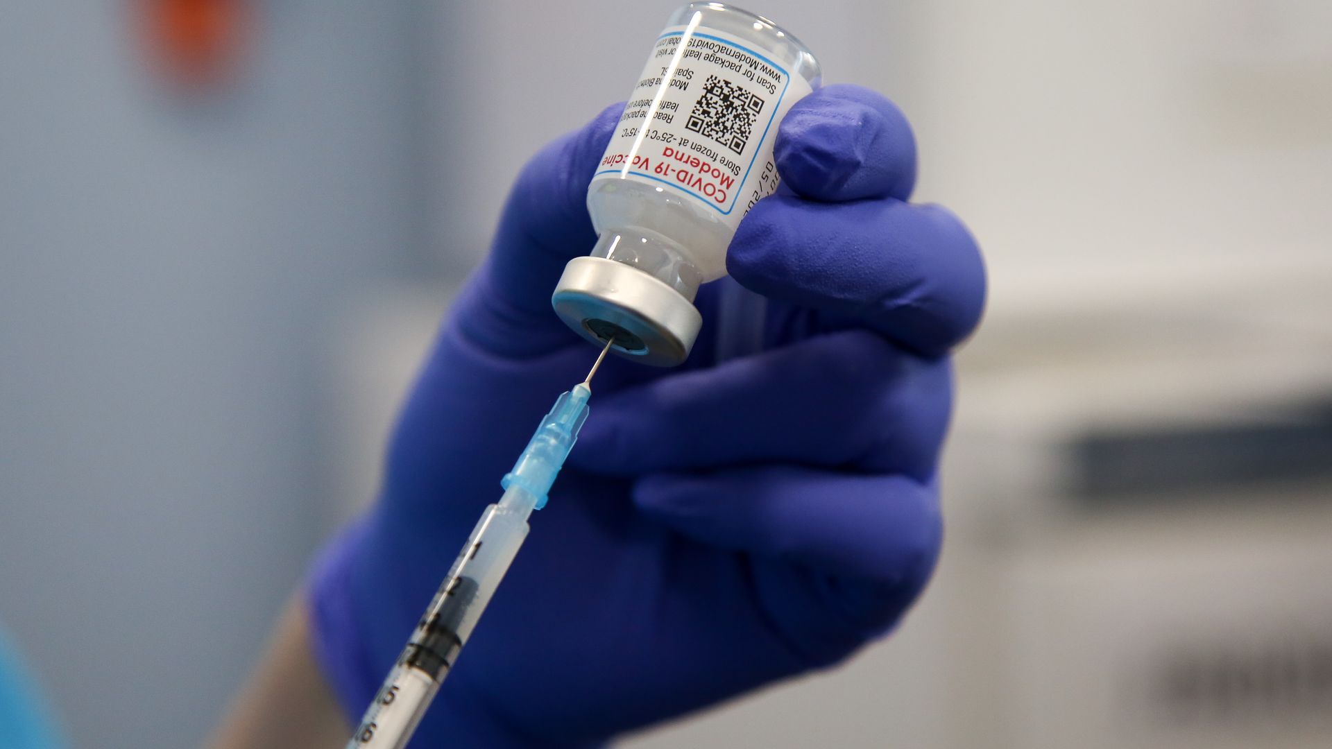 A health worker draws the Moderna COVID-19 vaccine.