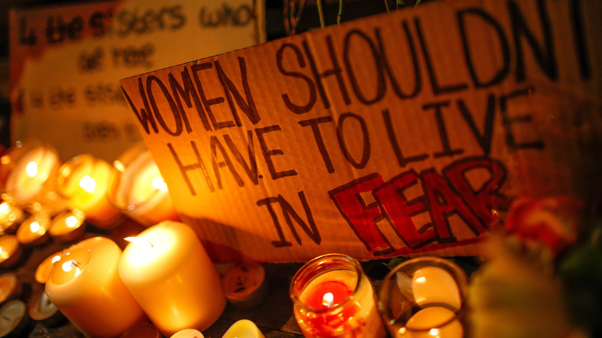 A placard rests amid candles on a bench as mourners hold a vigil for the life of murdered 33-year-old Sarah Everard