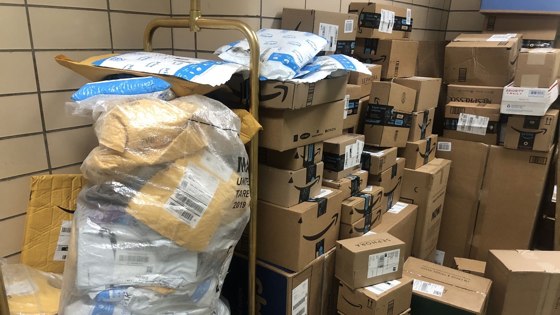 A large stack of amazon boxes and packages