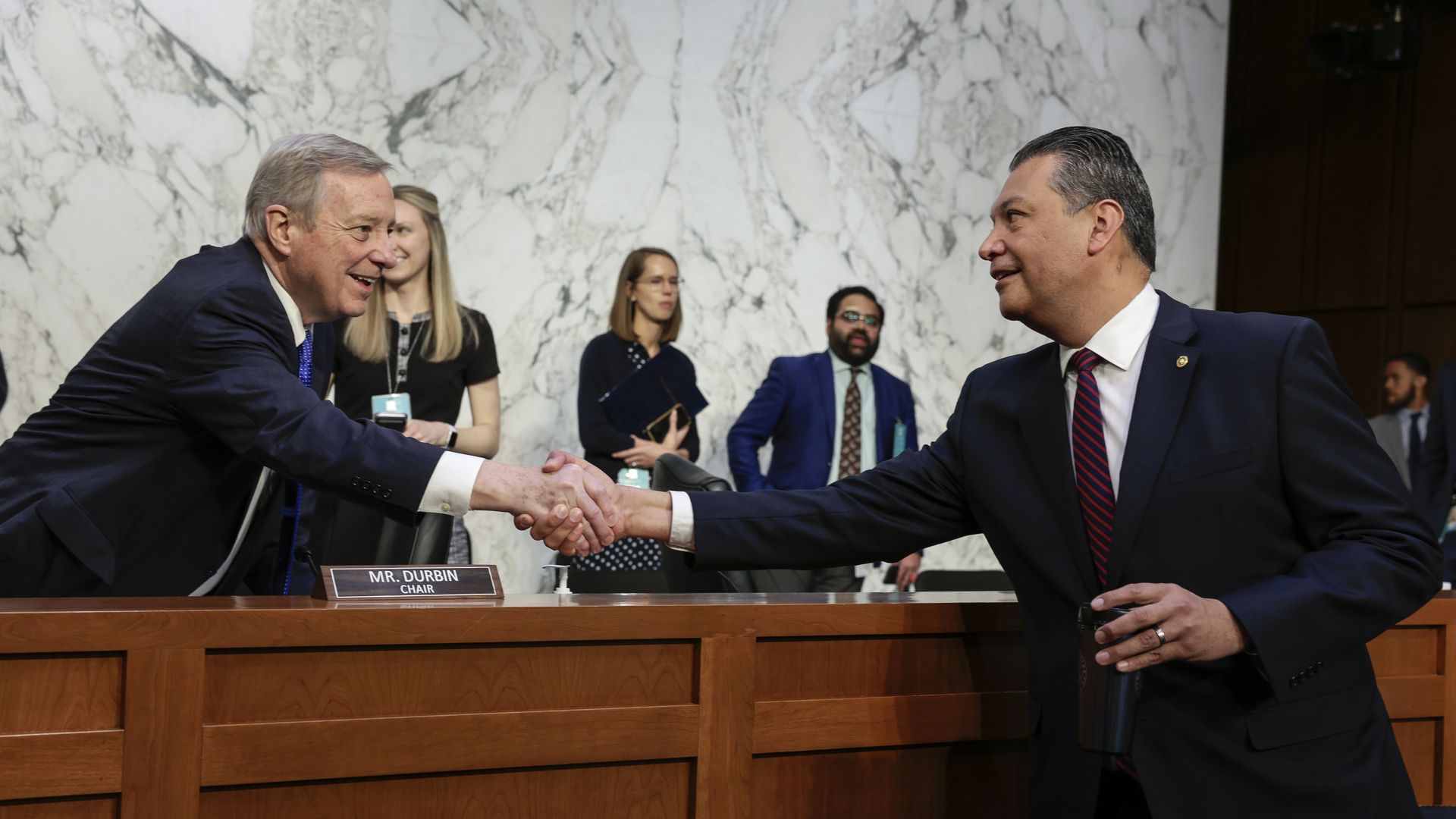 Sen. Dick Durbin (D-IL) shakes hands with Sen. Alex Padilla (D-CA) as he arrives late for a Senate Judiciary Committee business meeting to vote on Supreme Court nominee Judge Ketanji Brown Jackson