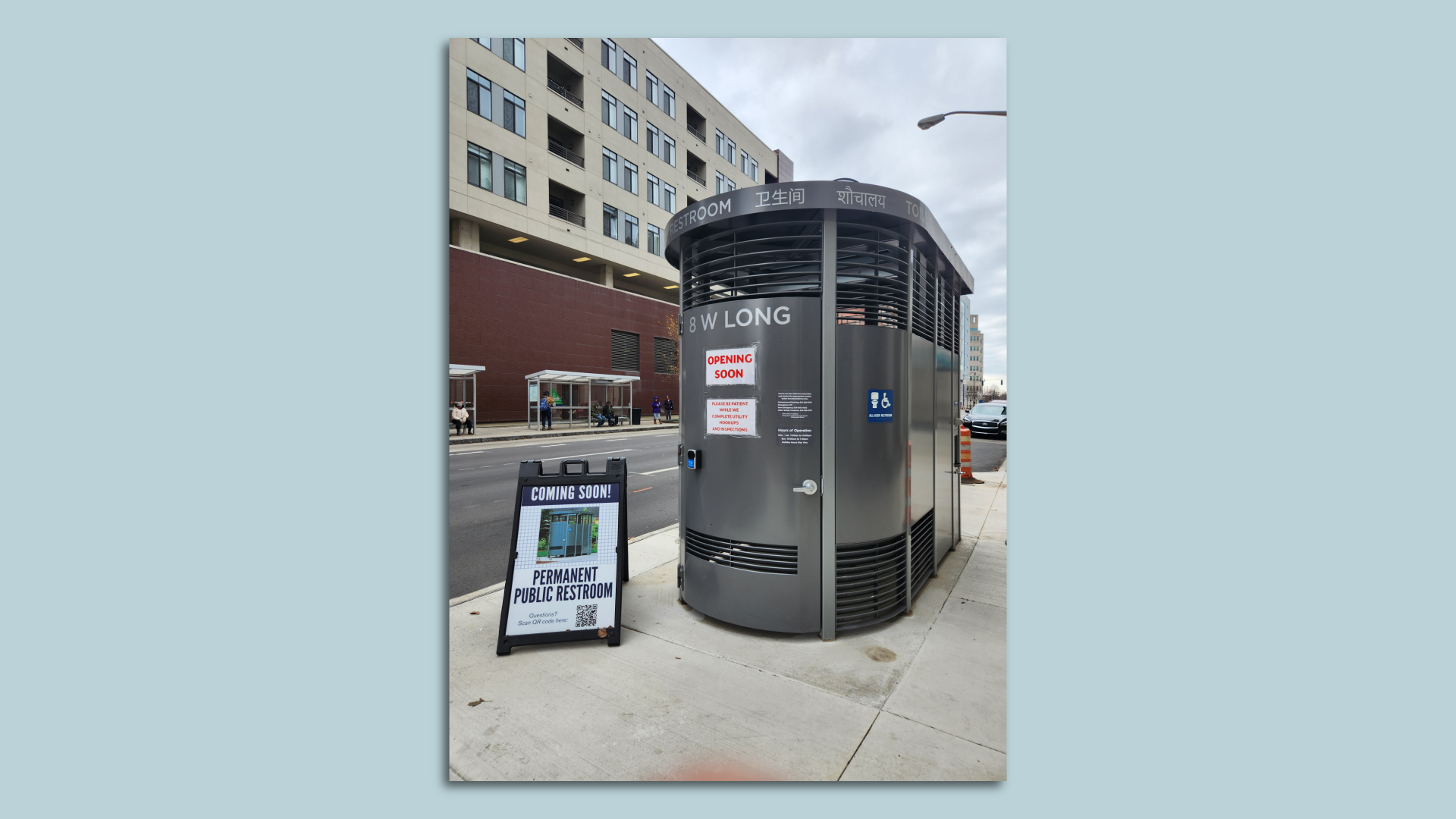 An outdoor bathroom installed on a sidewalk. 
