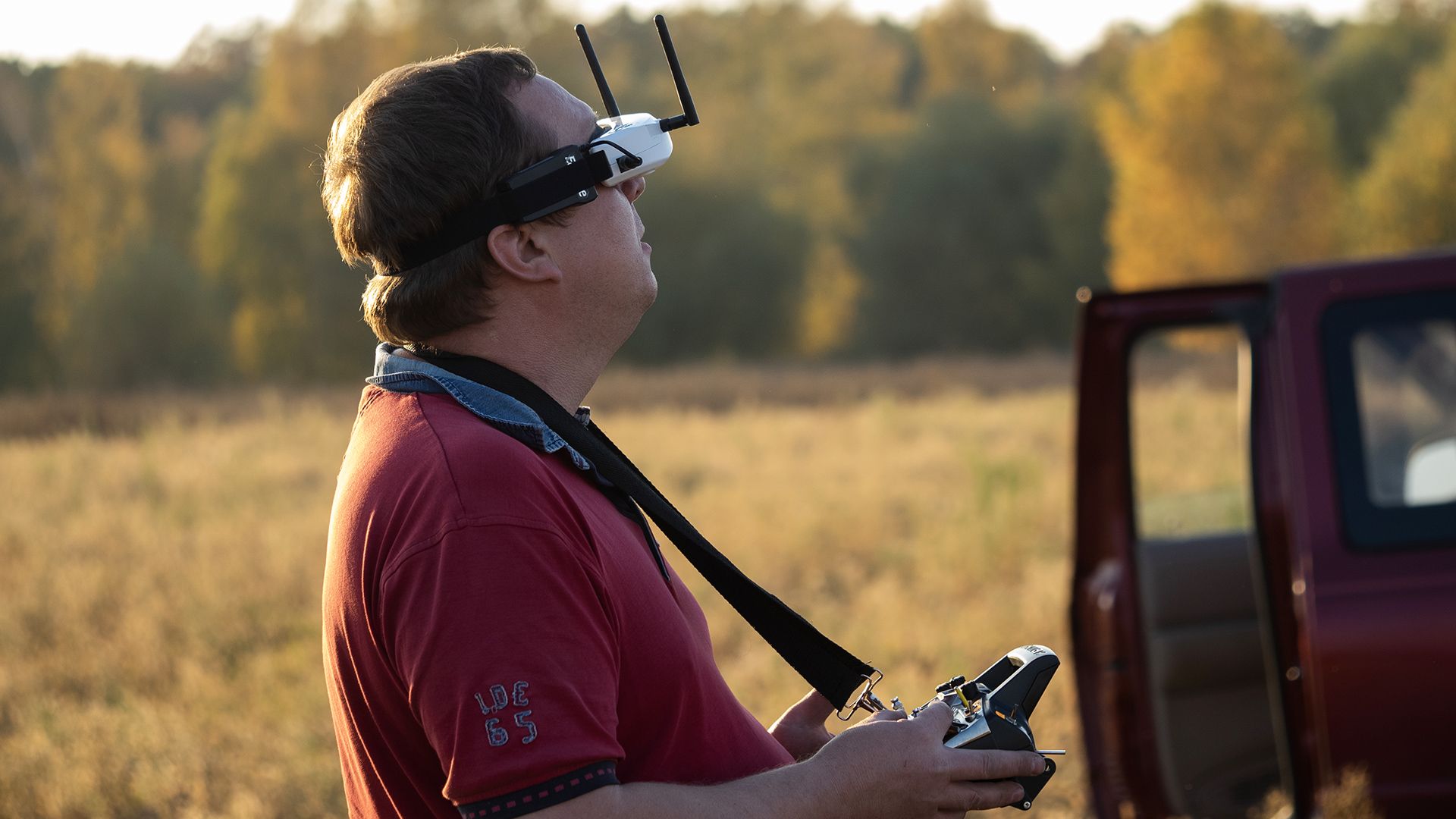 A man using a first-person headset to pilot a drone. 