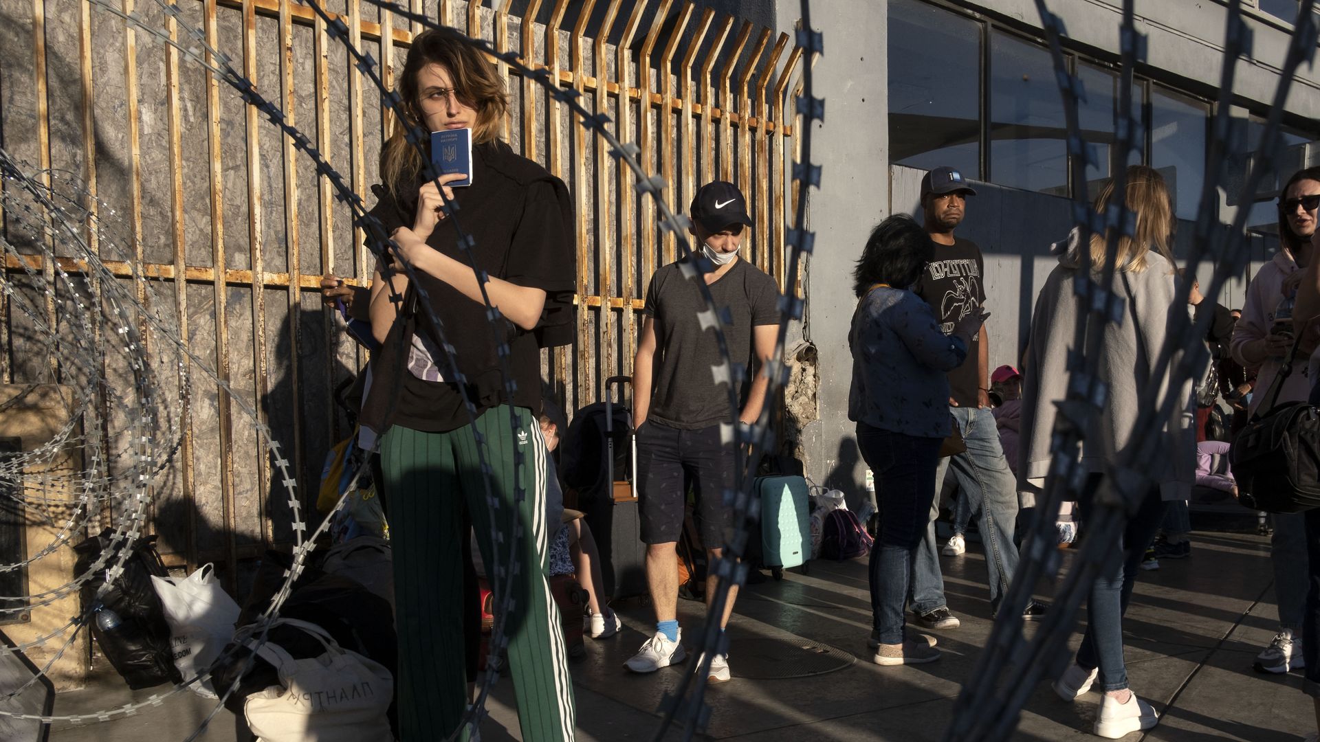 An asylum seeker from Ukraine waits with other asylum seekers from her country for US border authorities to allow them to cross the border at the Mexican side of the San Ysidro Crossing port