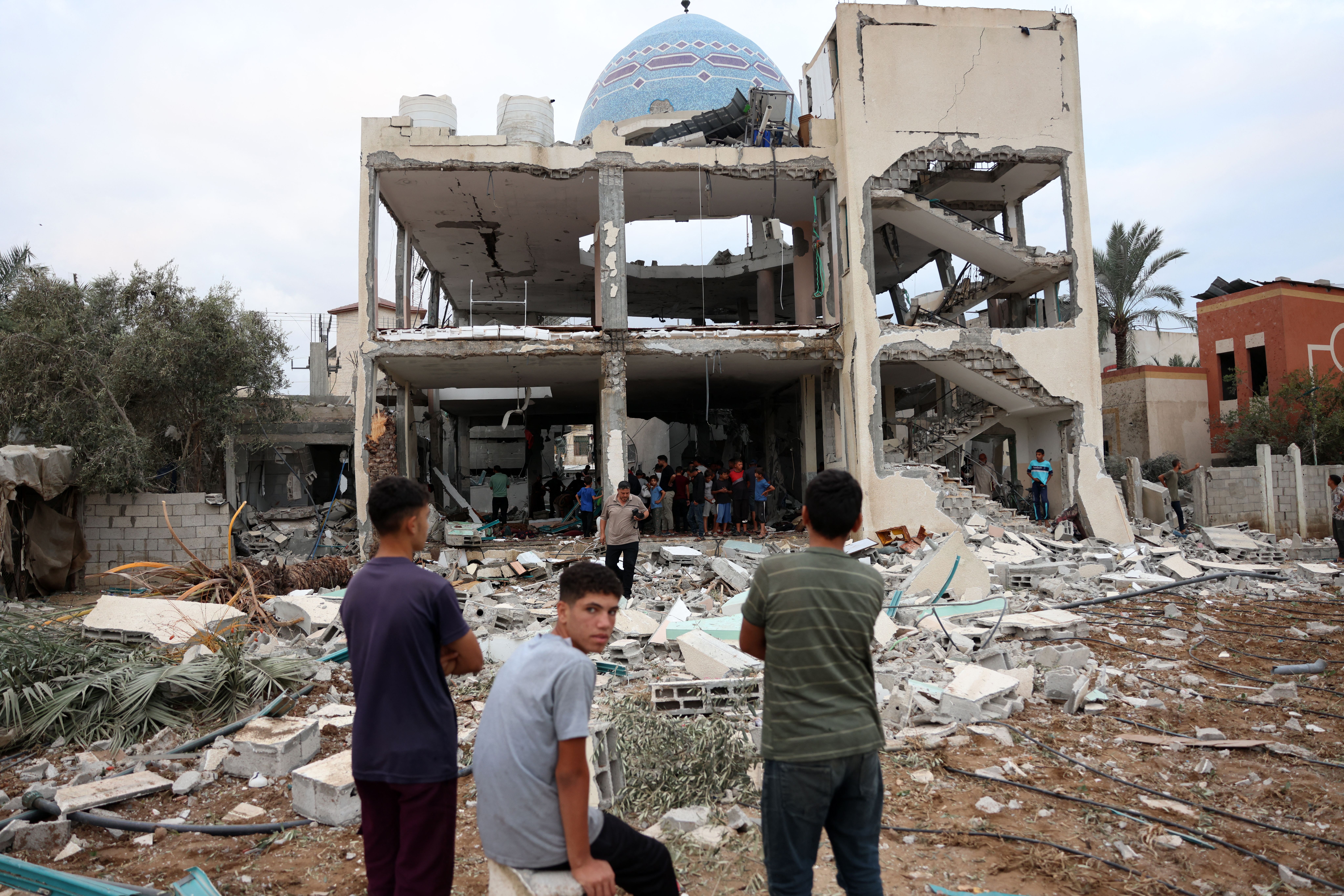 Palestinians look at a destroyed mosque in Deir al-Balah in central Gaza on Sunday.
