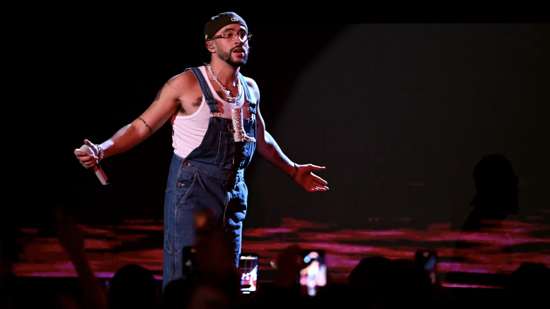 bad bunny in overalls and a hat on a stage